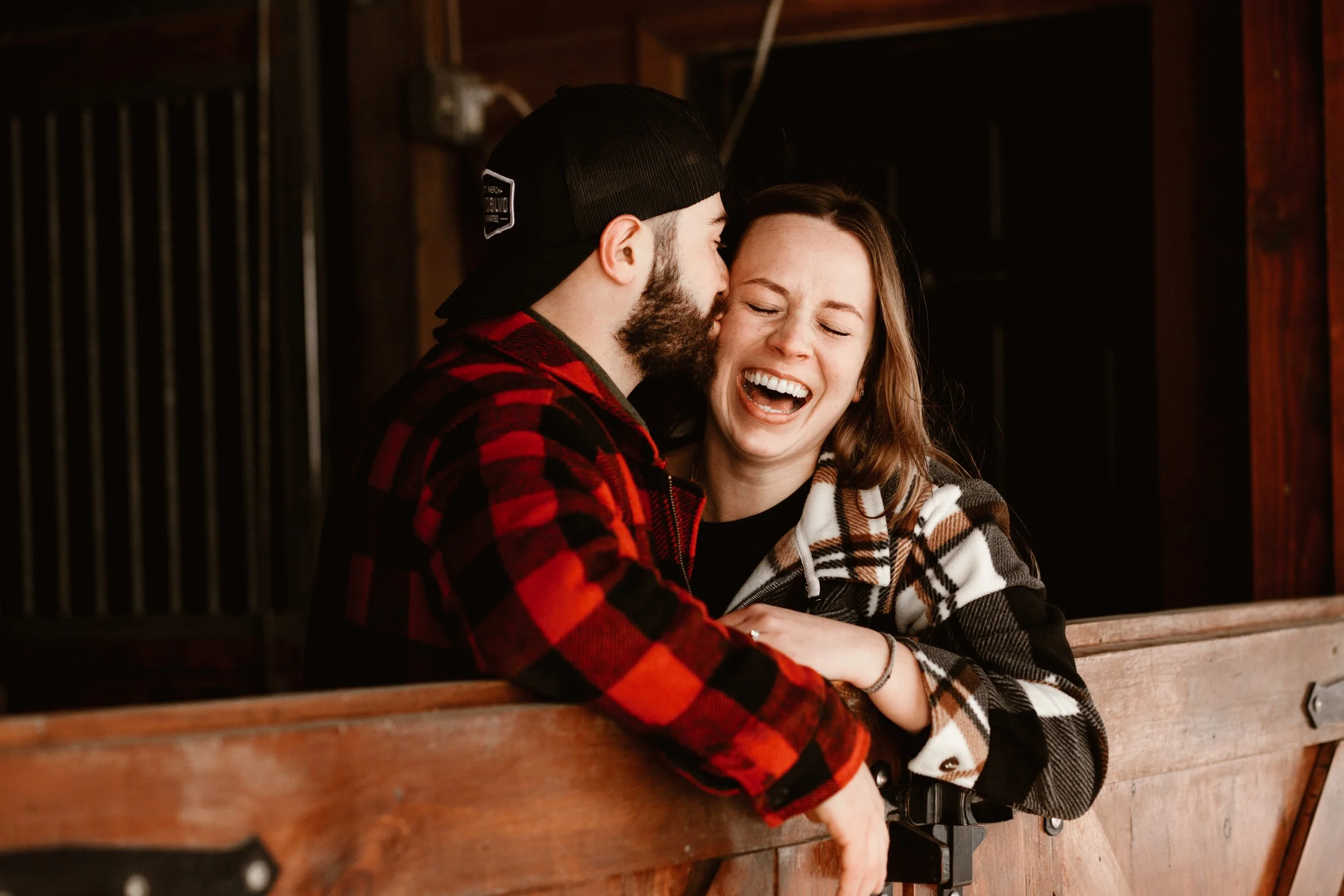 guy kissing his girlfriend as she laughs