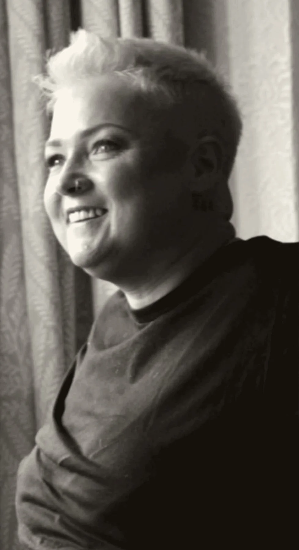 Jodie Jago, counsellor, smiling by a window