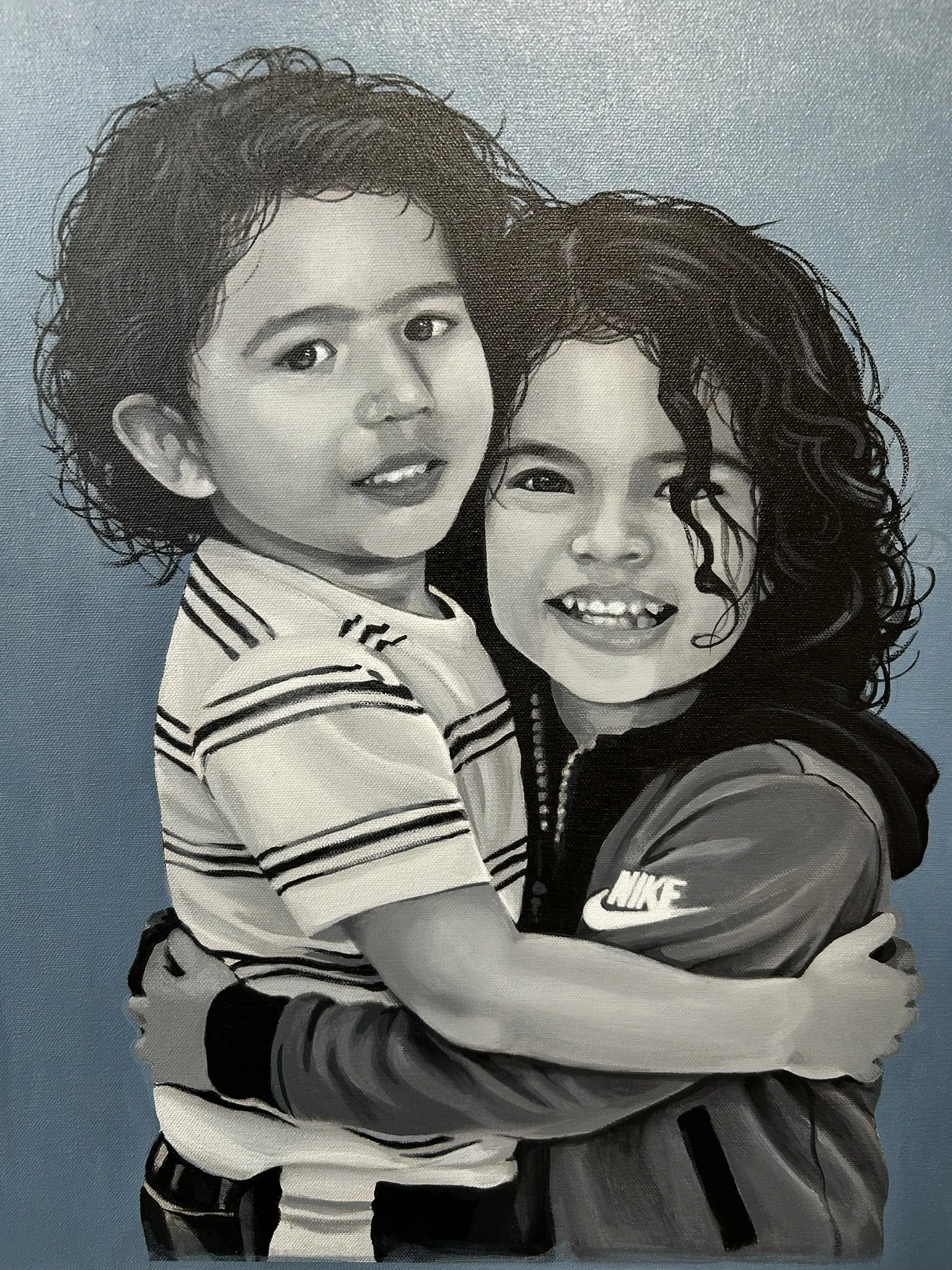 Illustration of a smiling young boy and girl hugging against a blue background