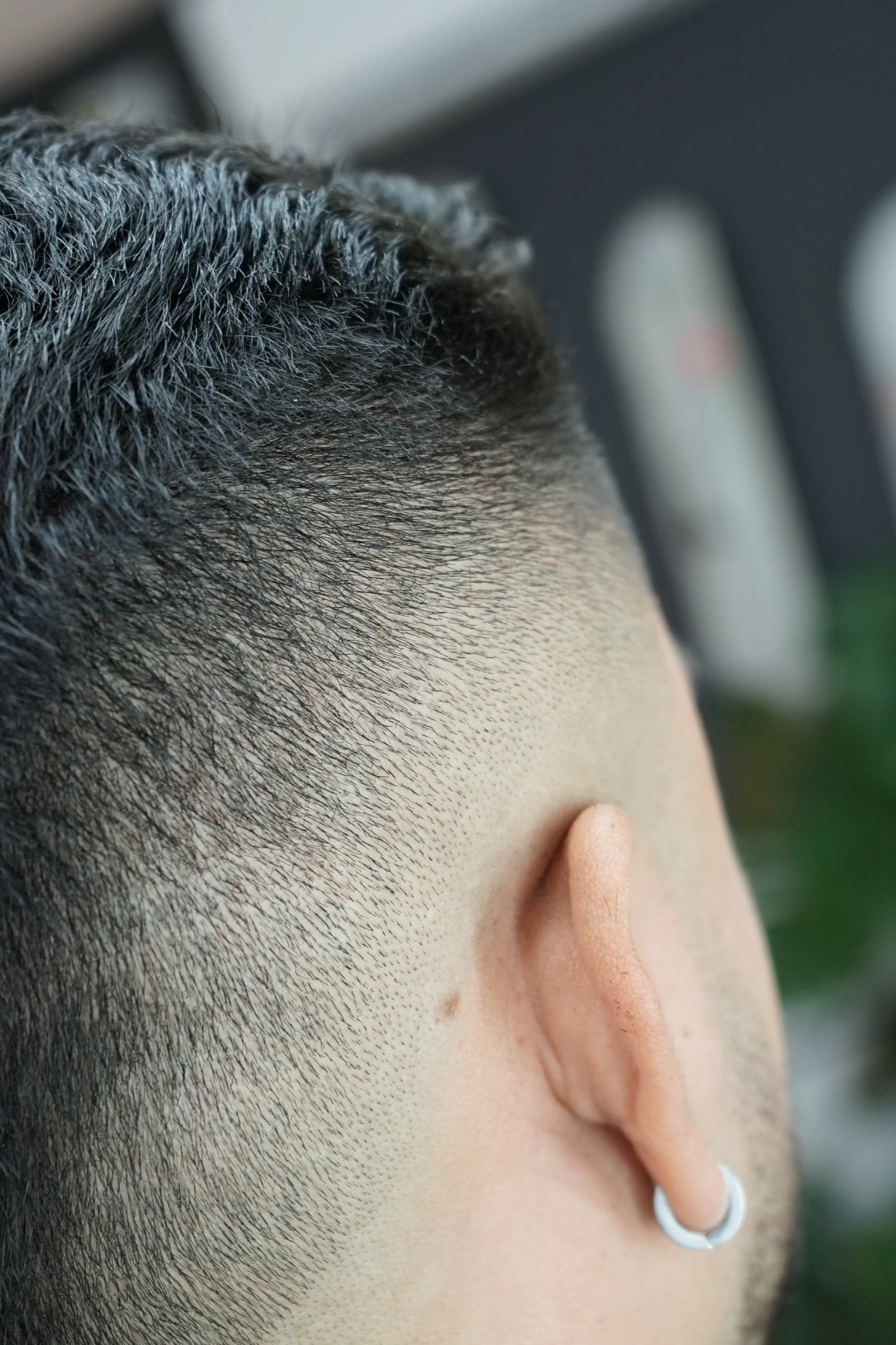 Close-up of a bearded man with a silver hoop earring