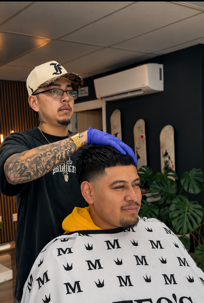 Barber wearing gloves trims a client's hair in a modern barbershop