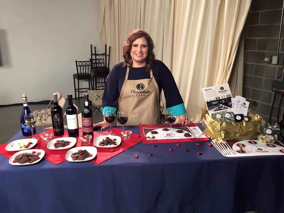 Keri Lauderdale Olson in a Chocolate Cork apron at a chocolate and wine pairing table.