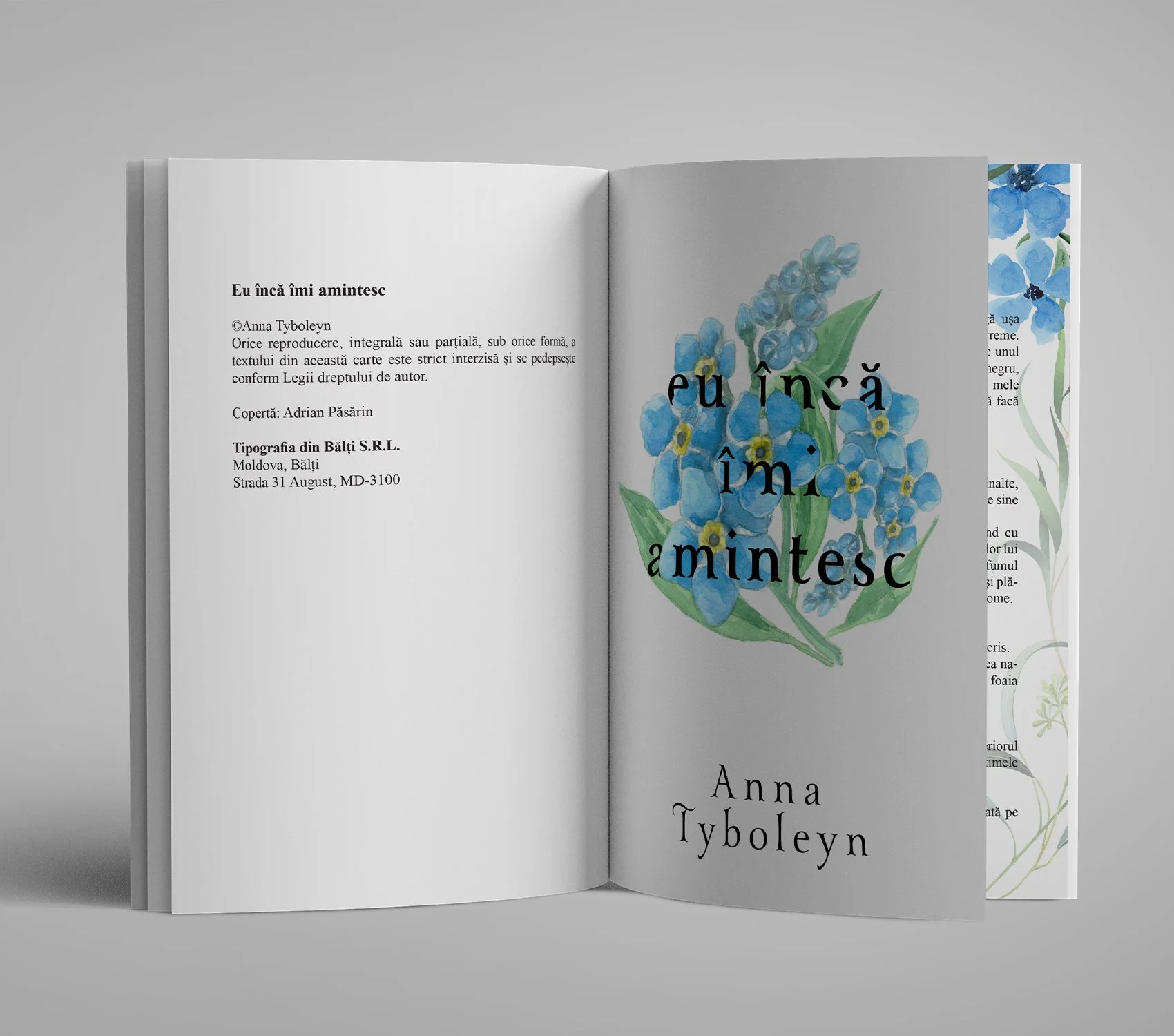 Open Romanian book titled "Eu încă îmi amintesc" by Anna Tyboleyn, featuring blue forget-me-not flowers and green leaves.