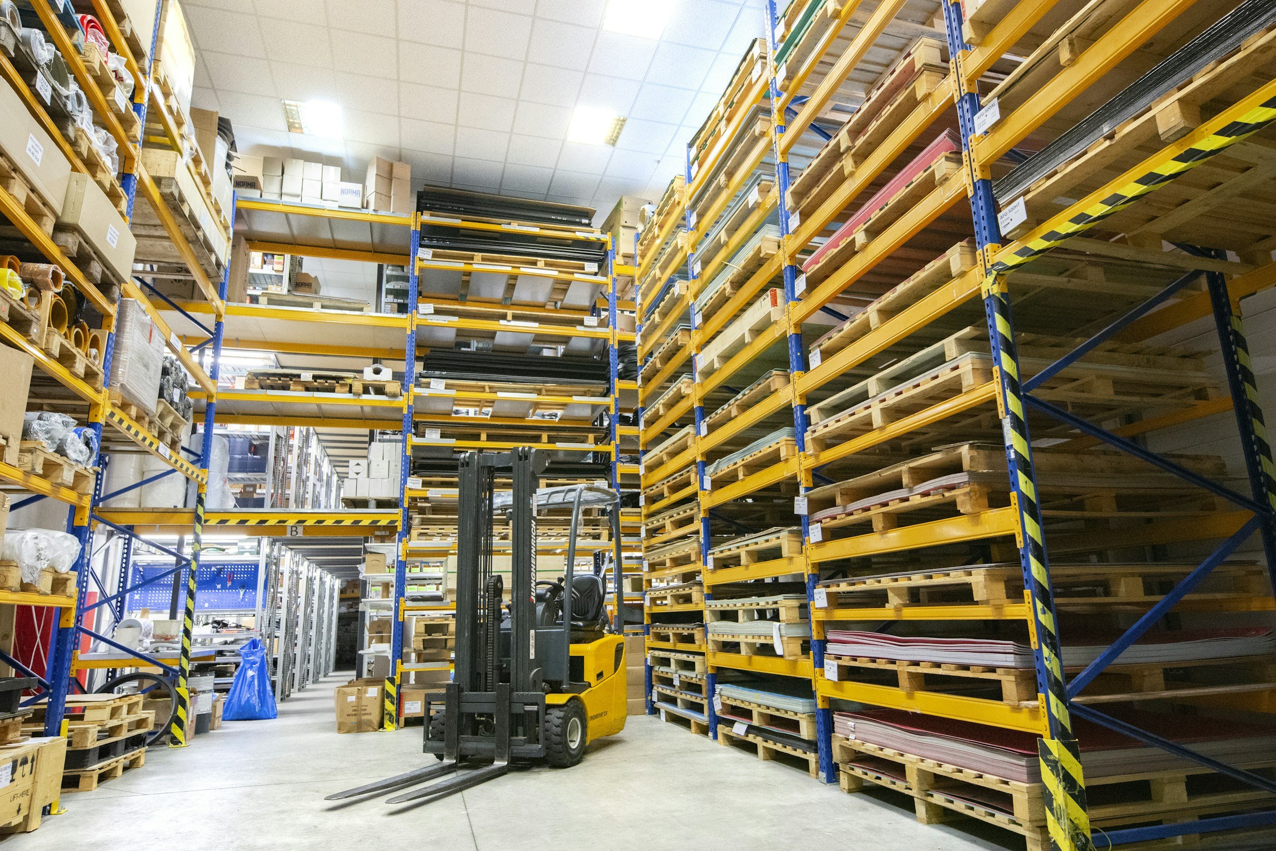 Warehouse shelves and forklift, stock photography