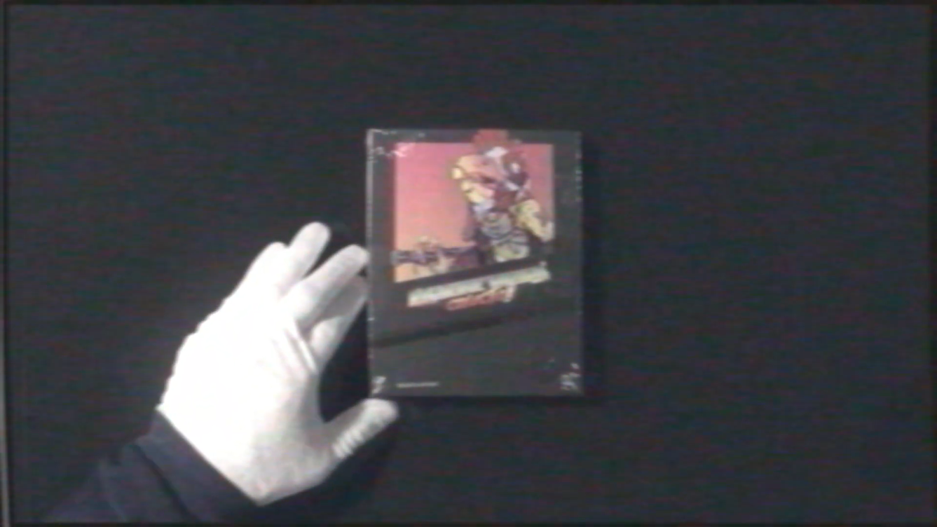 Gloved hand holding a vintage video game cartridge against a dark background
