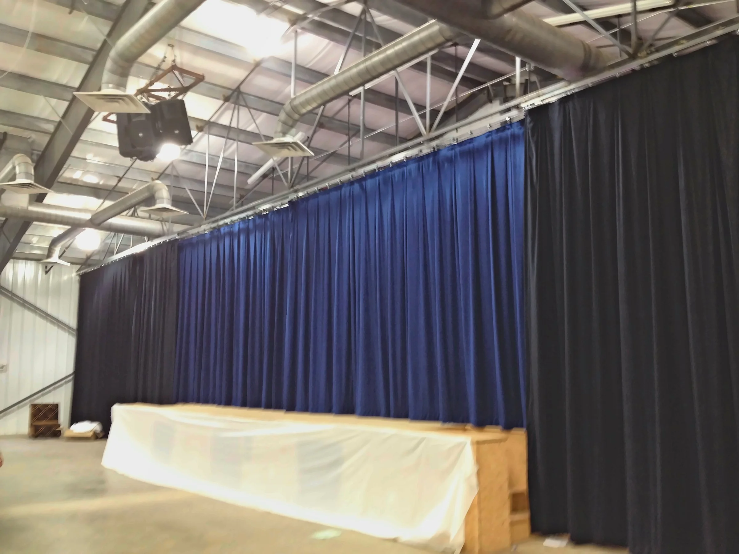 Blue stage curtain and black side curtains almost finished