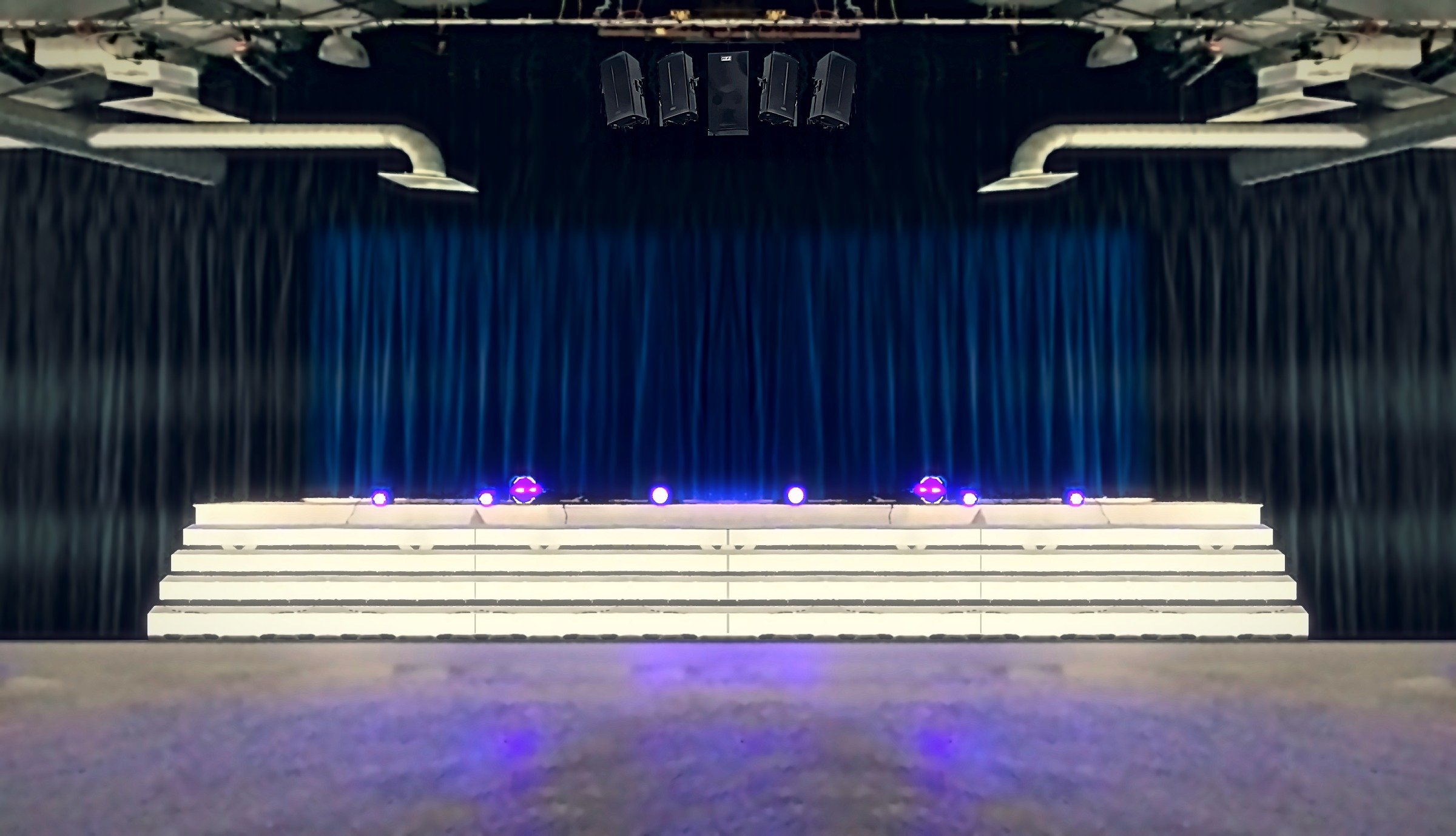 Finished theater stage with blue curtain, black side curtains, lighting and FBT speakers by Sandel Sound