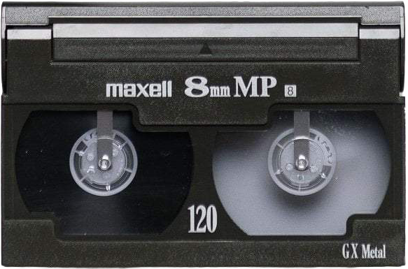 Close-up of a Maxell 8mm camcorder video cassette tape in black with two spools and labelled '120' tape length.