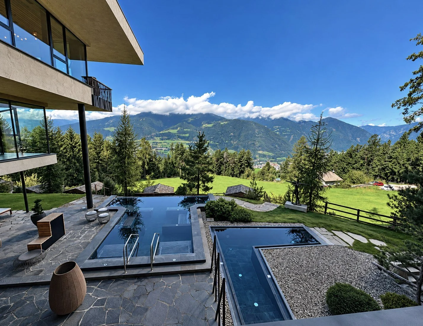 Outdoor pools and terrace at My Arbor above Brixen, with forest and South Tyrol mountains beyond
