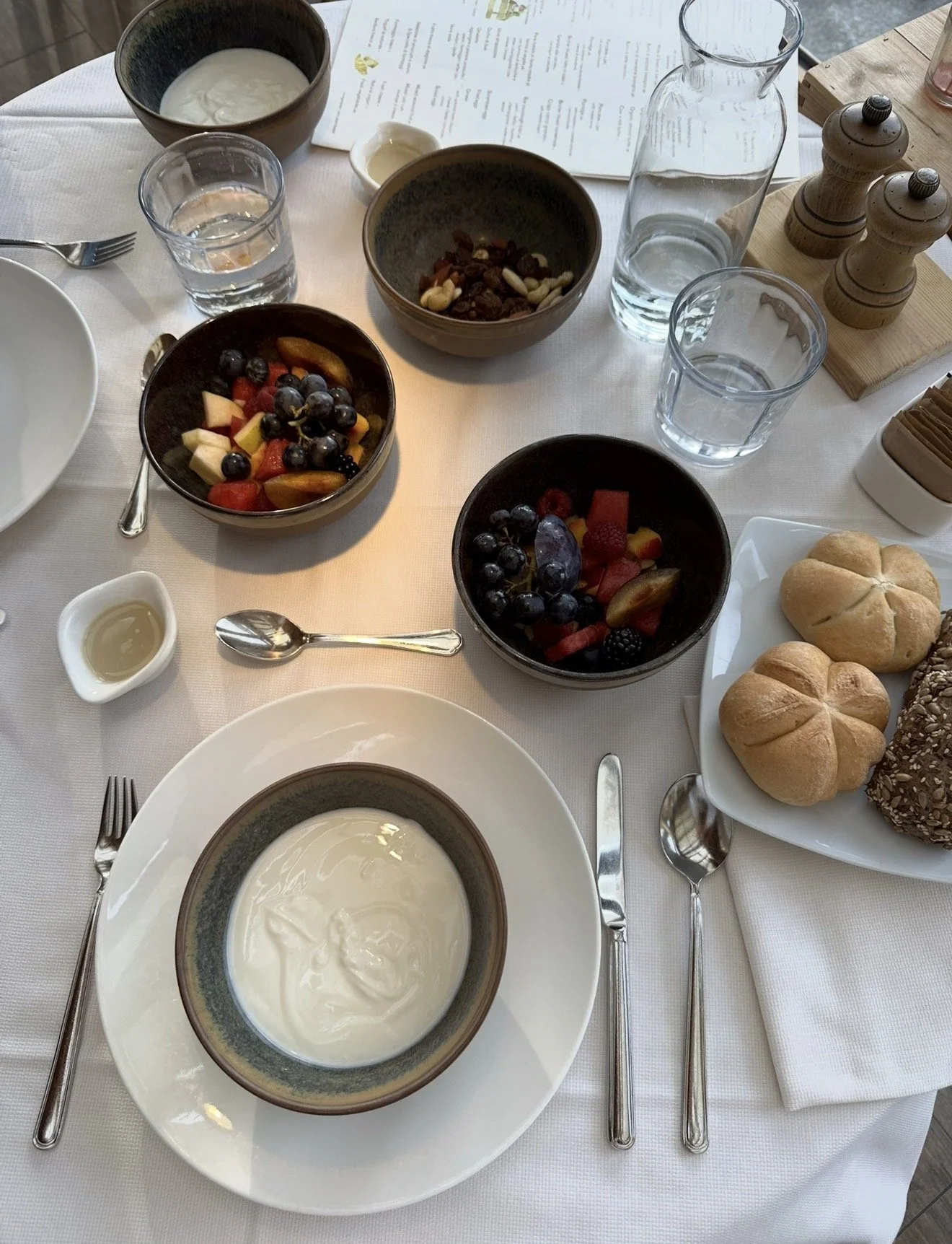 Breakfast at Saltus: yoghurt, fresh fruit, nuts and bread rolls