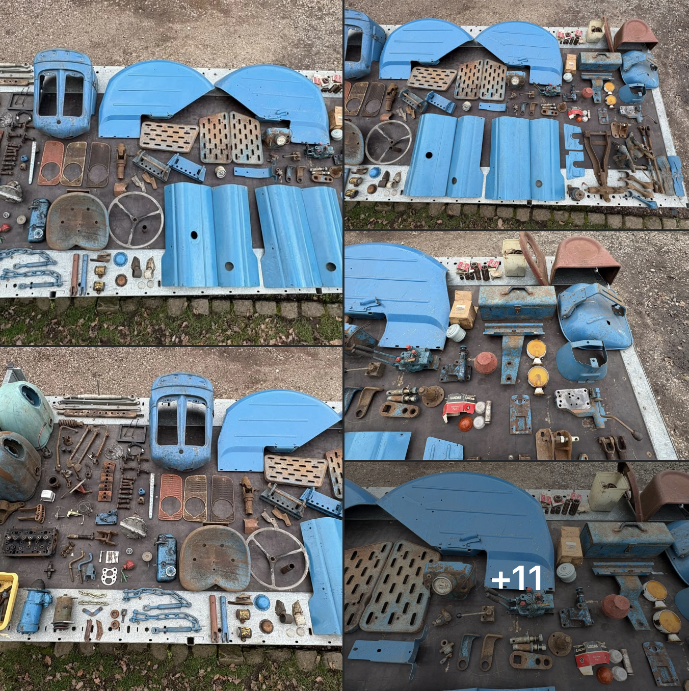 Disassembled blue vintage tractor parts, including body panels, fenders, engine components, tools, gauges, and hardware arranged on display boards.