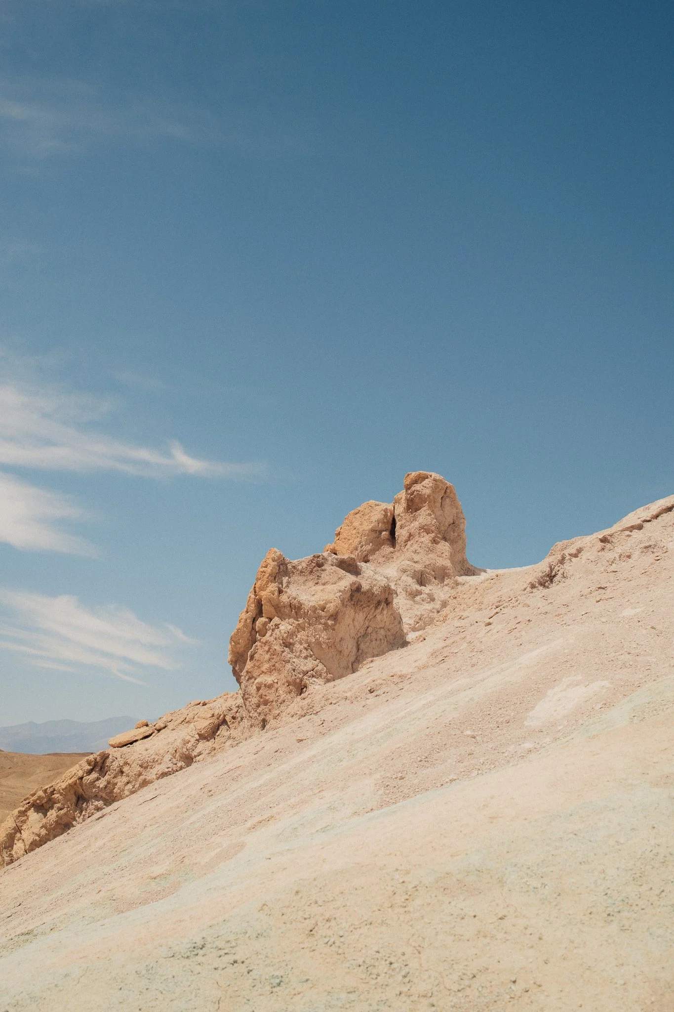 Sunlit desert rock formations beneath a clear blue sky