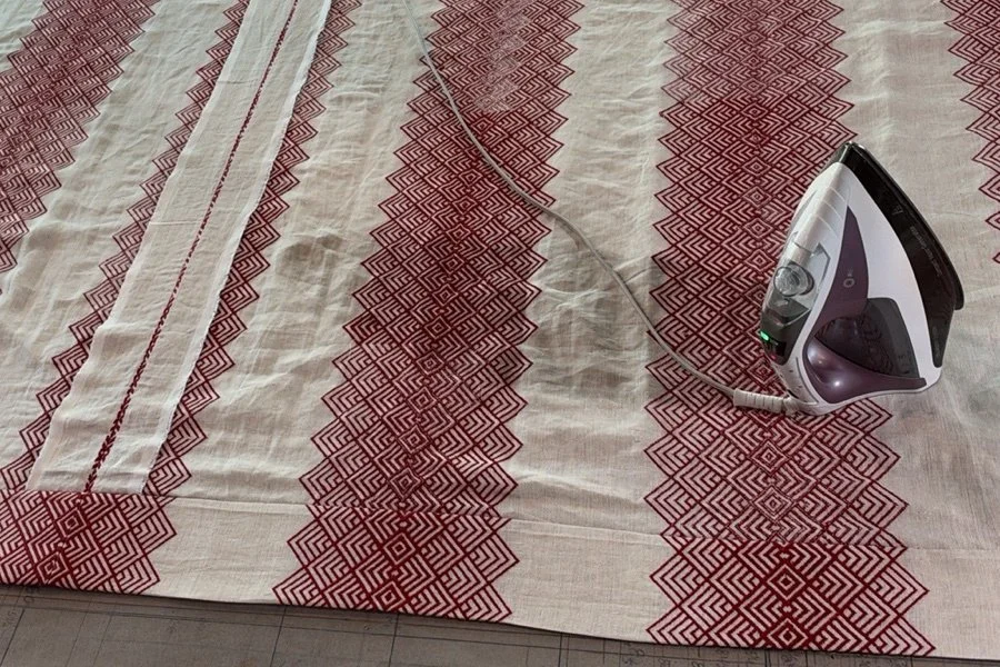 Cherokee red fabric pressed on the workroom table