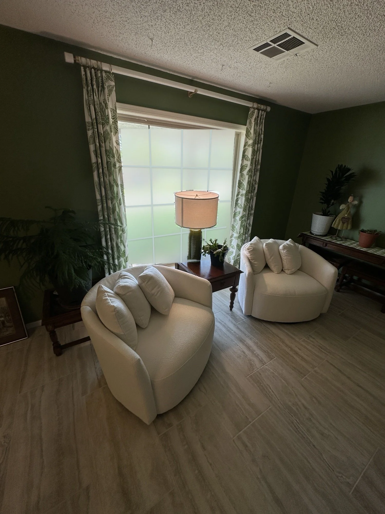 Botanical print panels, floor length, drawn wide to frame a sunlit window.