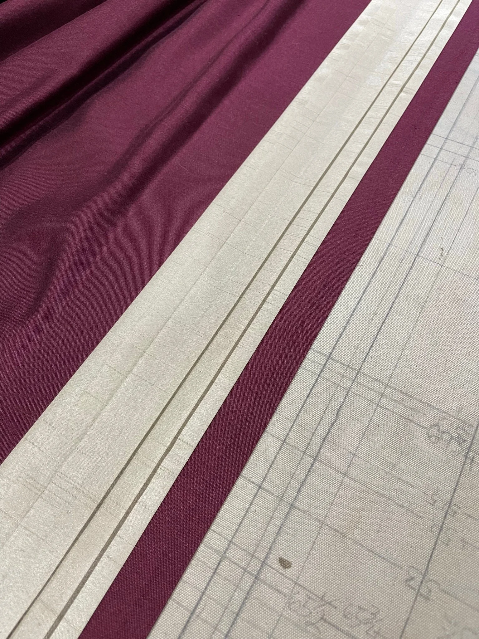 Plum and ivory, squared on the cutting table.