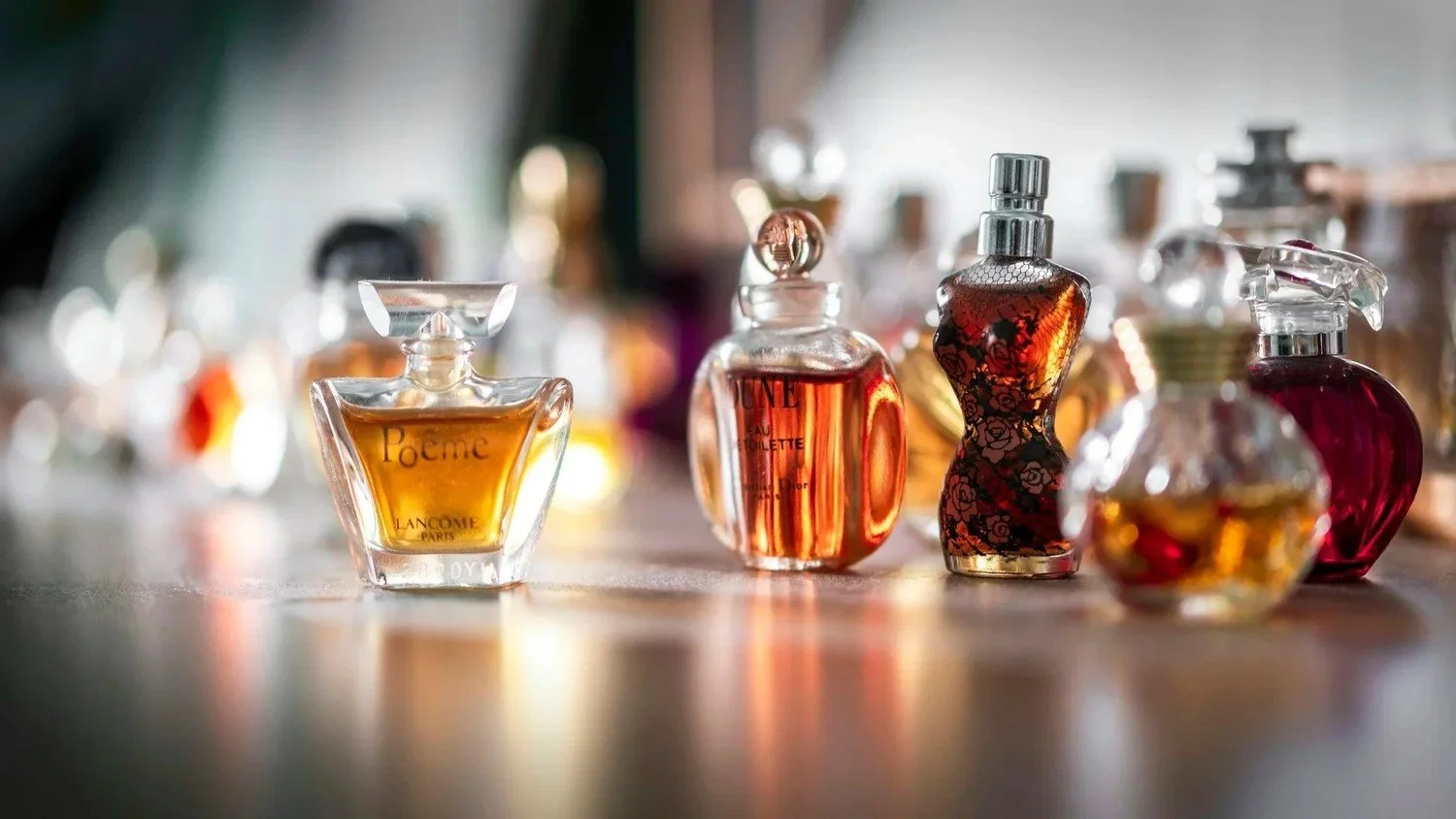 Perfume bottles and beauty essentials glowing on a vanity