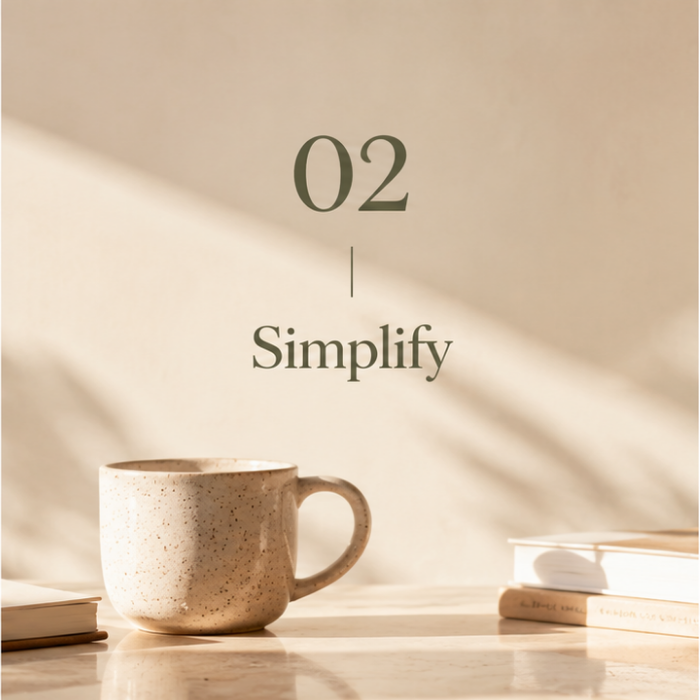 Step 2 – Simplify: Coffee cup and books in a sunlit workspace, representing simpler business systems and processes