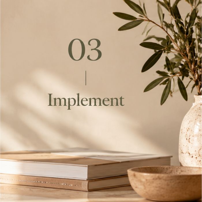 Step 3 – Implement: Books and olive branches in a warm workspace, representing practical business improvements