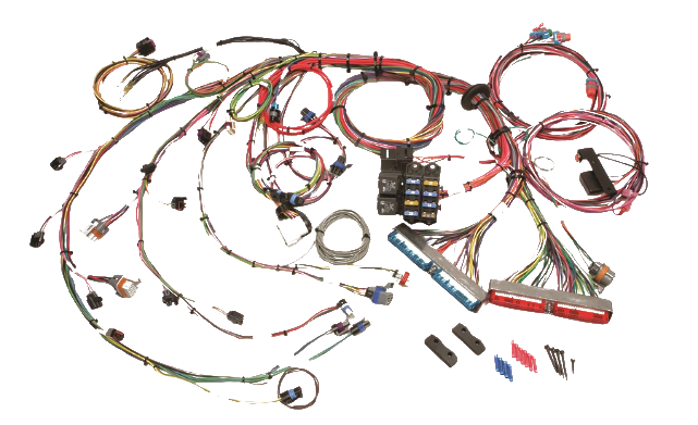 Overhead view of assorted electronic components, circuit boards, wiring harnesses, connectors, relays, and tools
