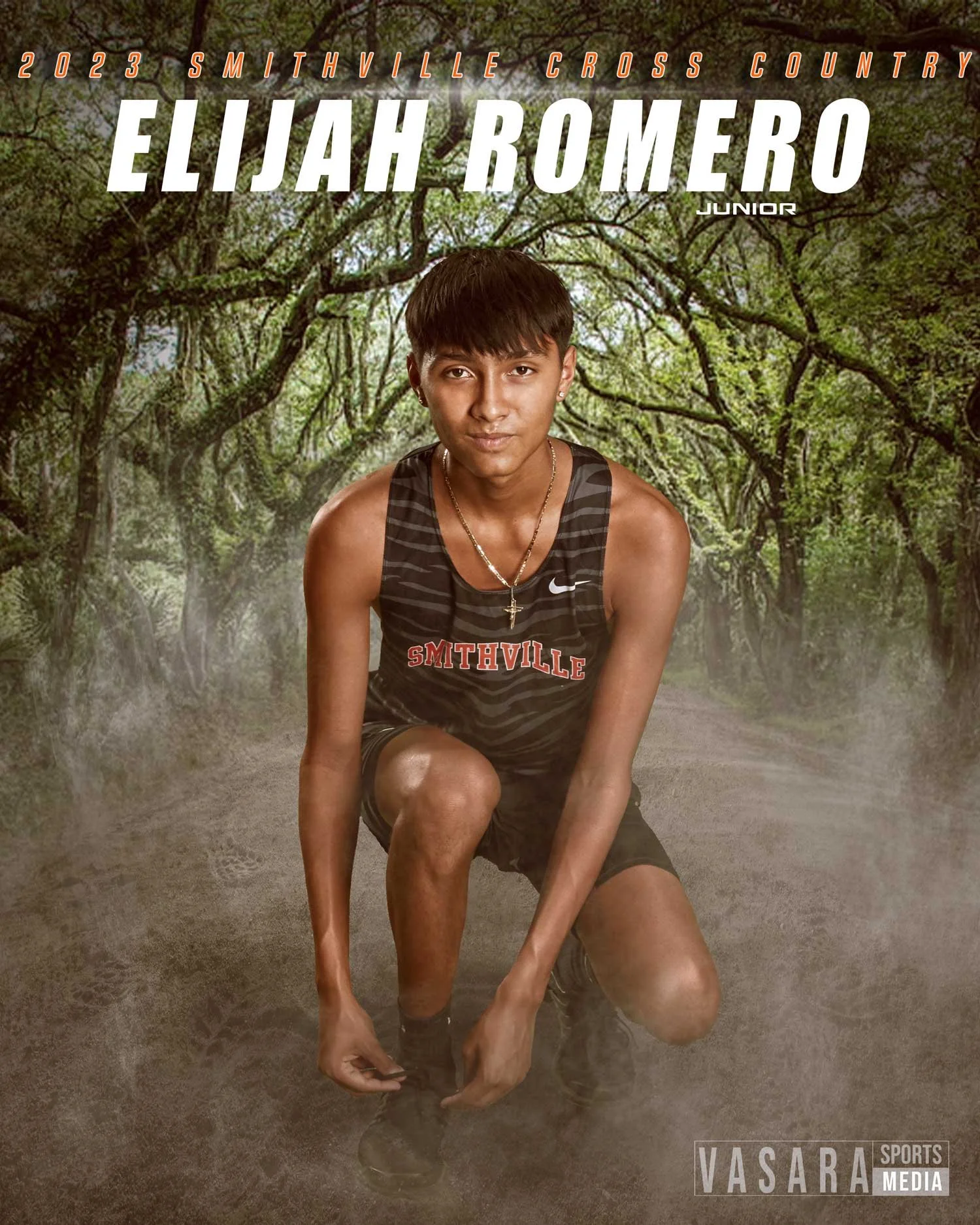 A young male cross country runner in a black and gray striped Smithville team uniform kneels on a dirt trail in a foggy forest. He has short dark hair, wears a necklace with a cross, and looks at the camera with a focused expression. The background features green trees and the text 'Elijah Romero Junior' with additional details about a cross country event.