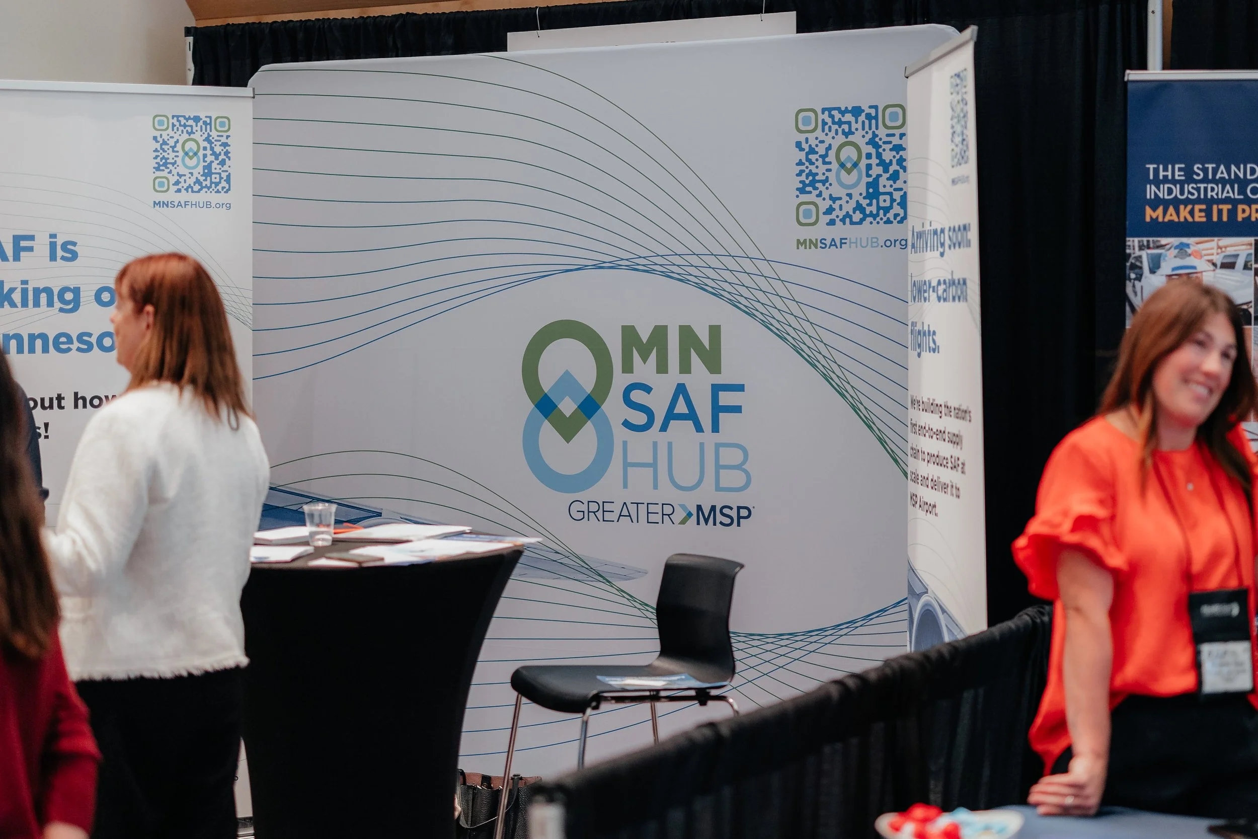 Minnesota Safety Hub trade show booth with QR codes, promotional banners, and attendees