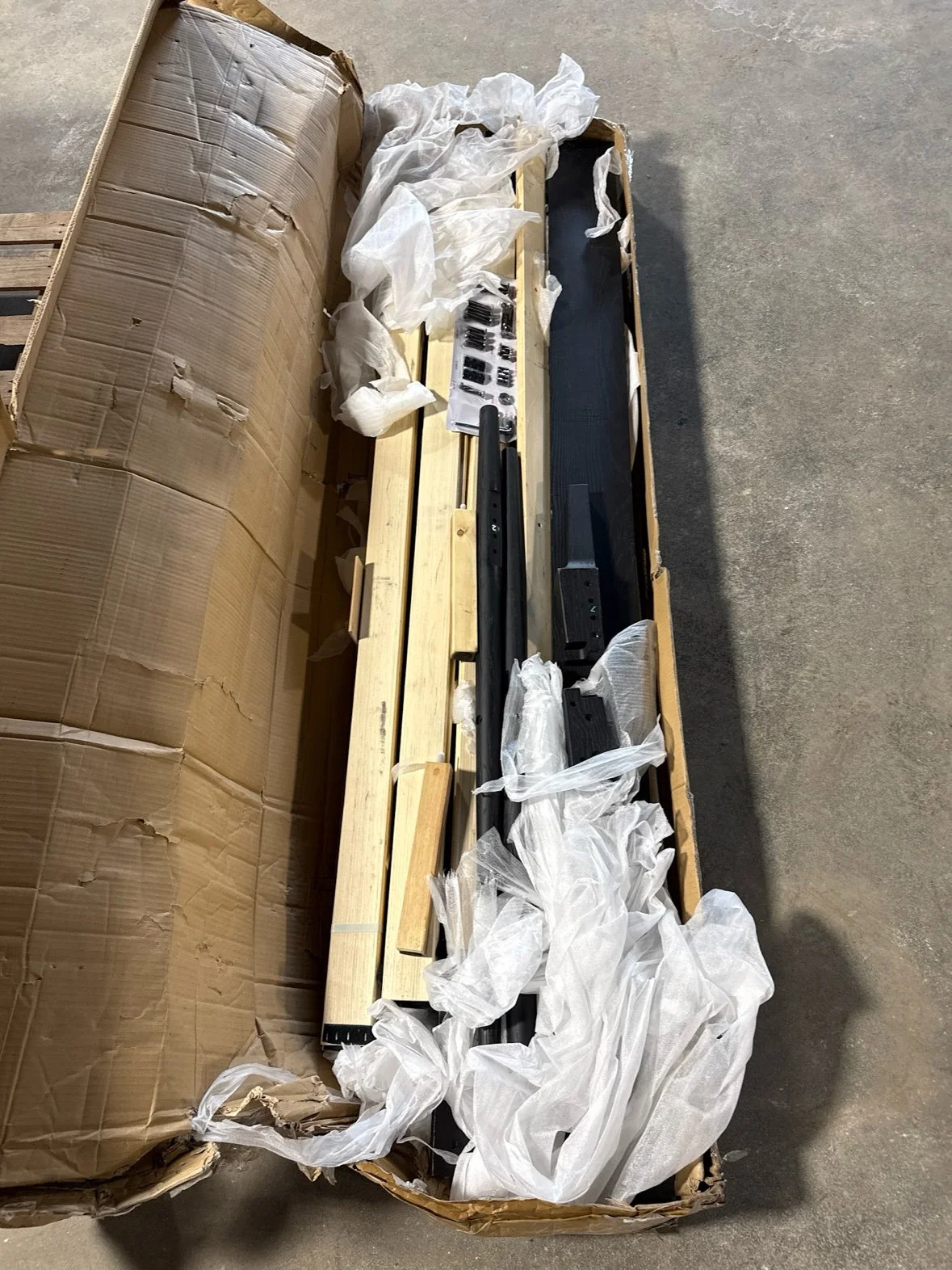 NTC Ruby Solid Wood Platform Bed With Natural Rattan Headboard – Queen, Burnt Black in its box at our Sylvania Bargain Bin warehouse