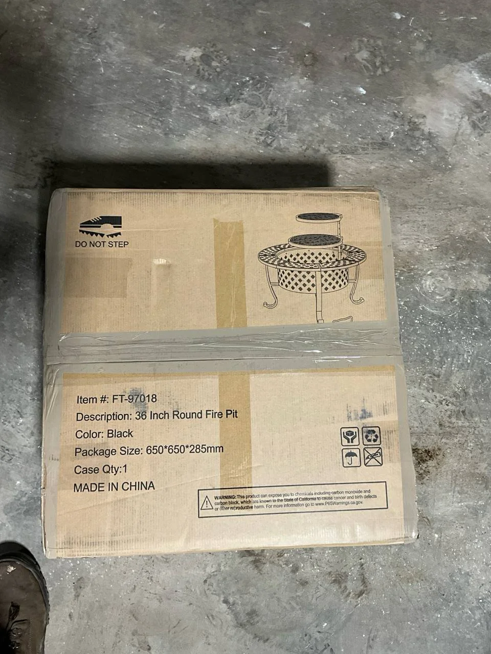 Sealed cardboard box for the Outvue 36-inch metal fire pit, as stored in the warehouse