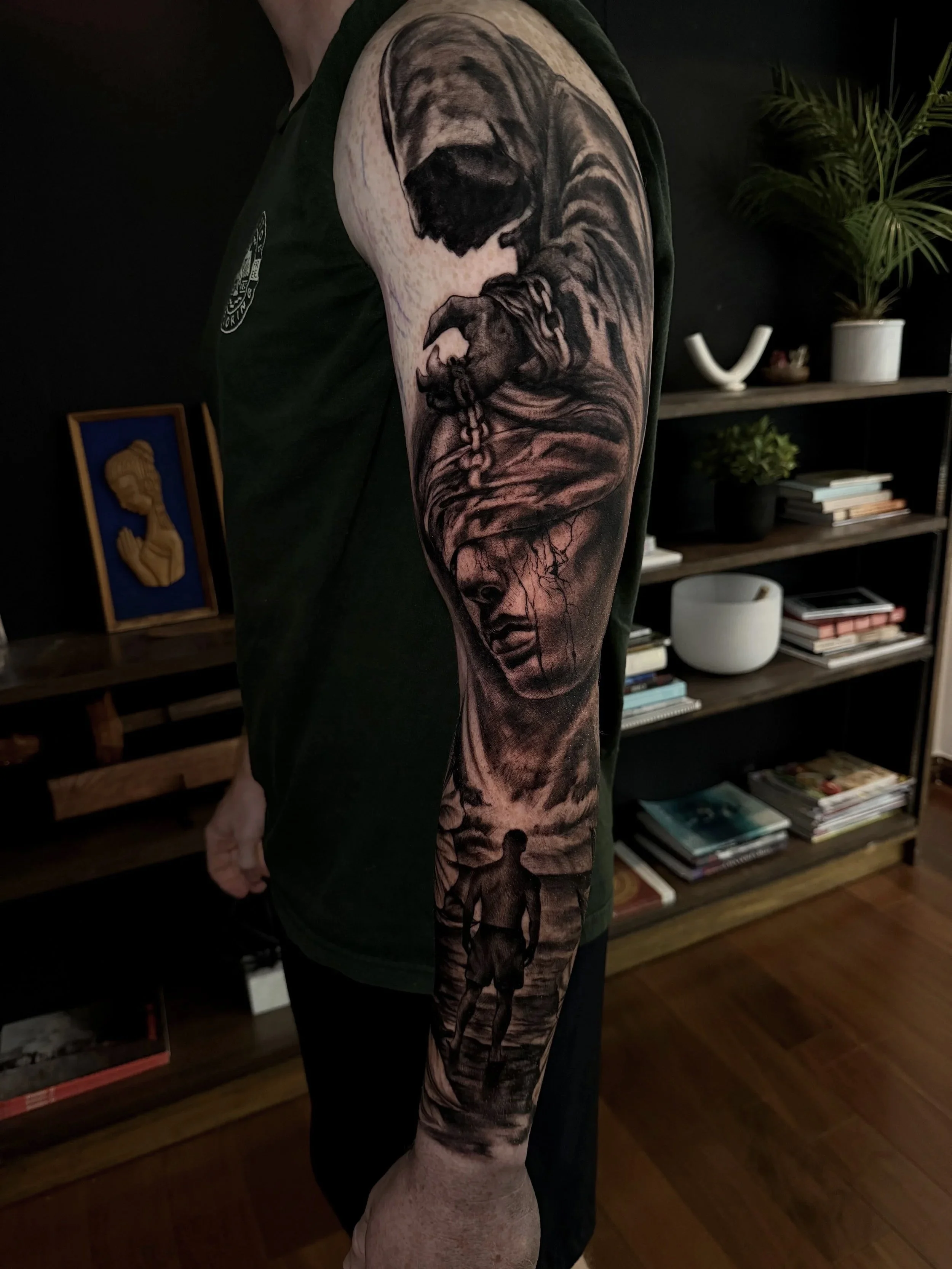 Close-up of a person’s arm featuring a detailed black-and-gray tattoo of a snarling tiger with bared teeth