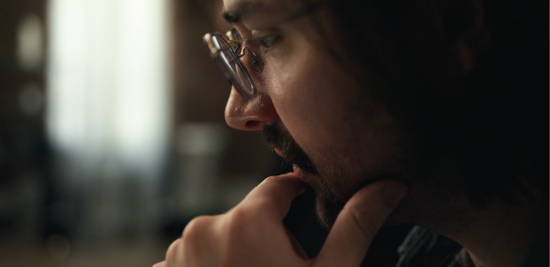 A bearded man in glasses in profile, still from The New Operating System of Hollywood, a film for Cinapse