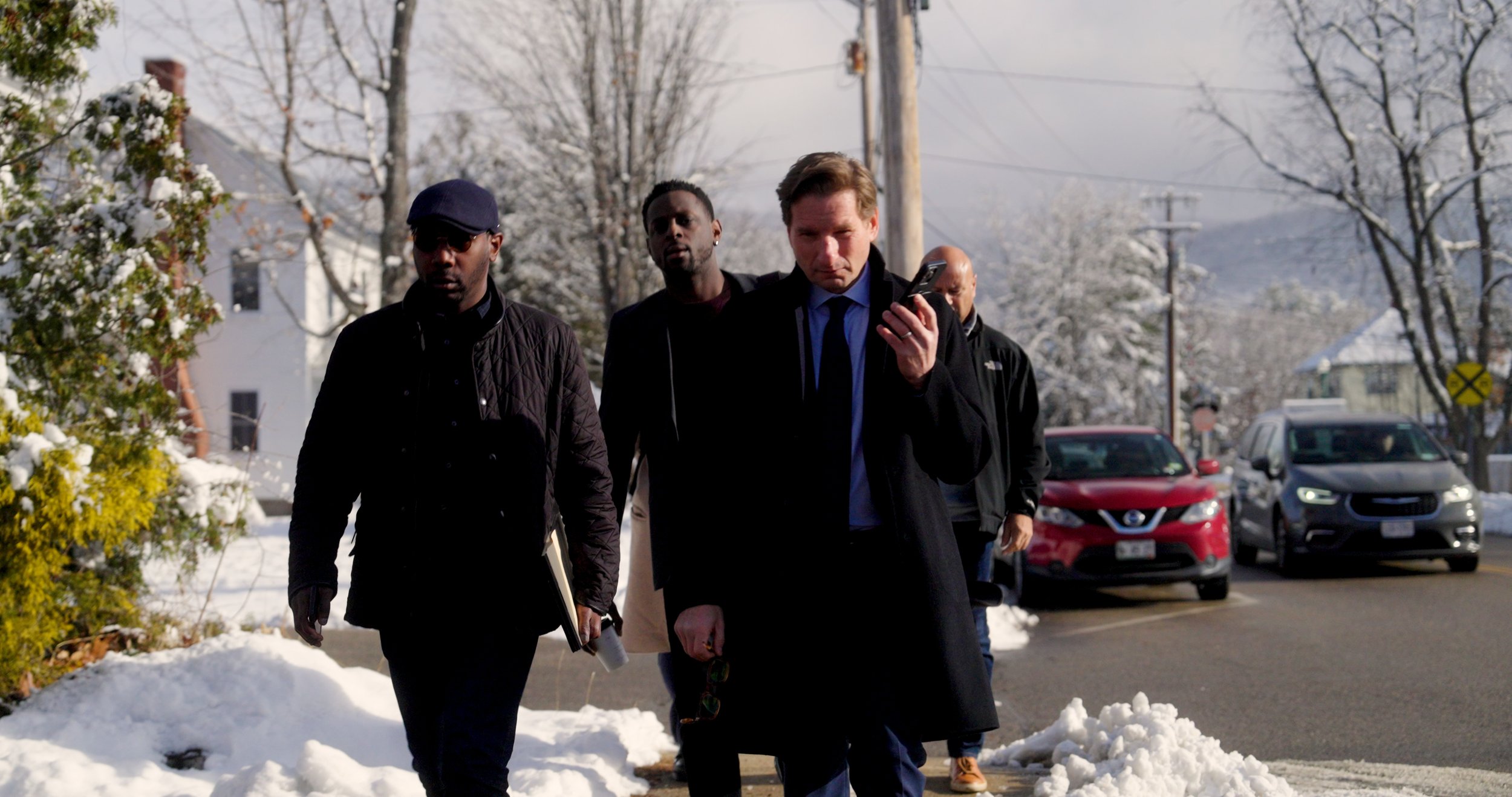 Four men walking through a snowy neighborhood, still from North Carolina Ballot Access for Dean Phillips for President
