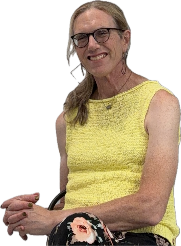 K. Davina Frick smiling warmly, wearing glasses and a yellow sleeveless top.