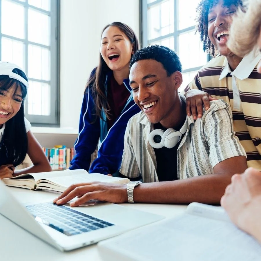 College students studying together and laughing at a table