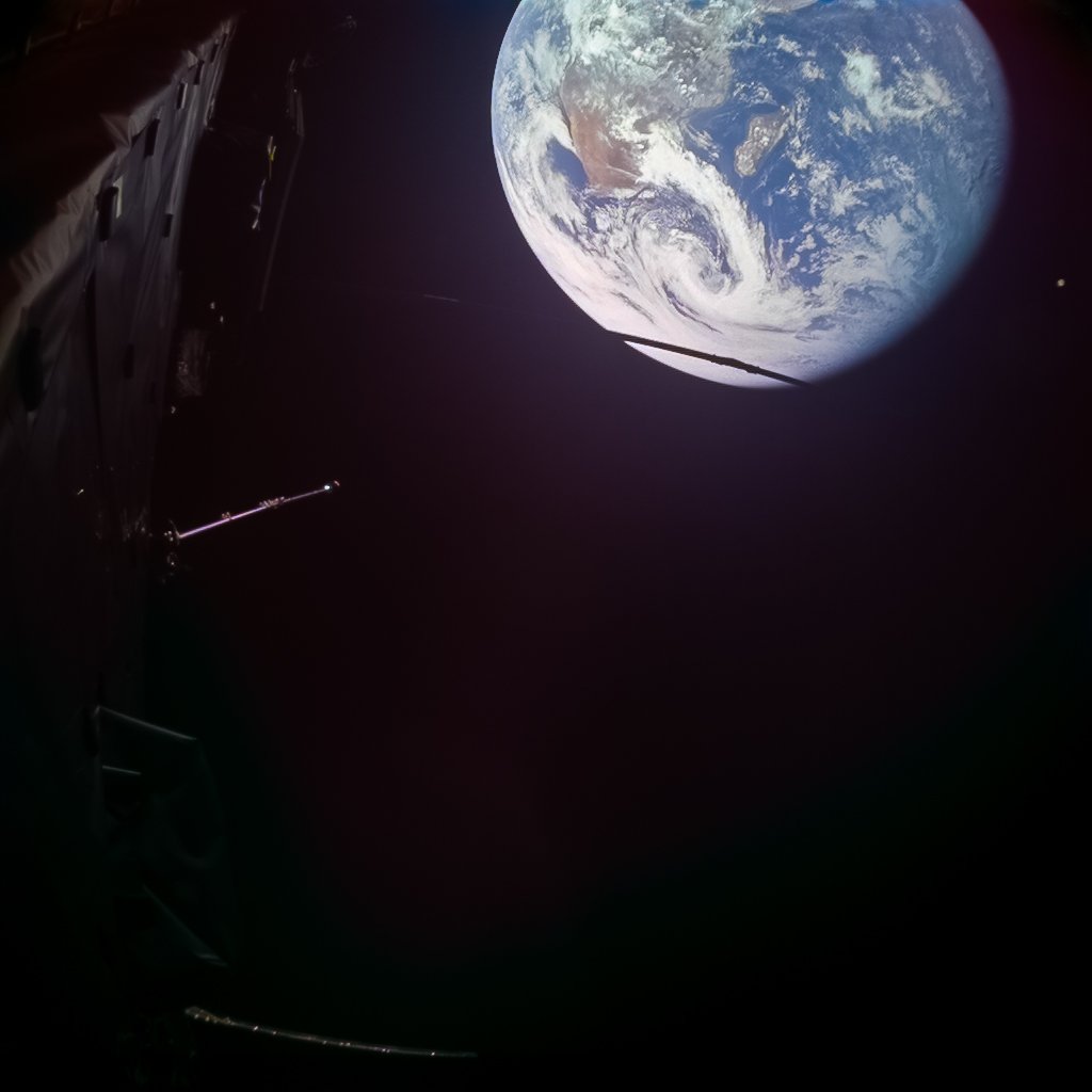 Earth viewed from space with clouds and ocean visible beside a spacecraft in darkness