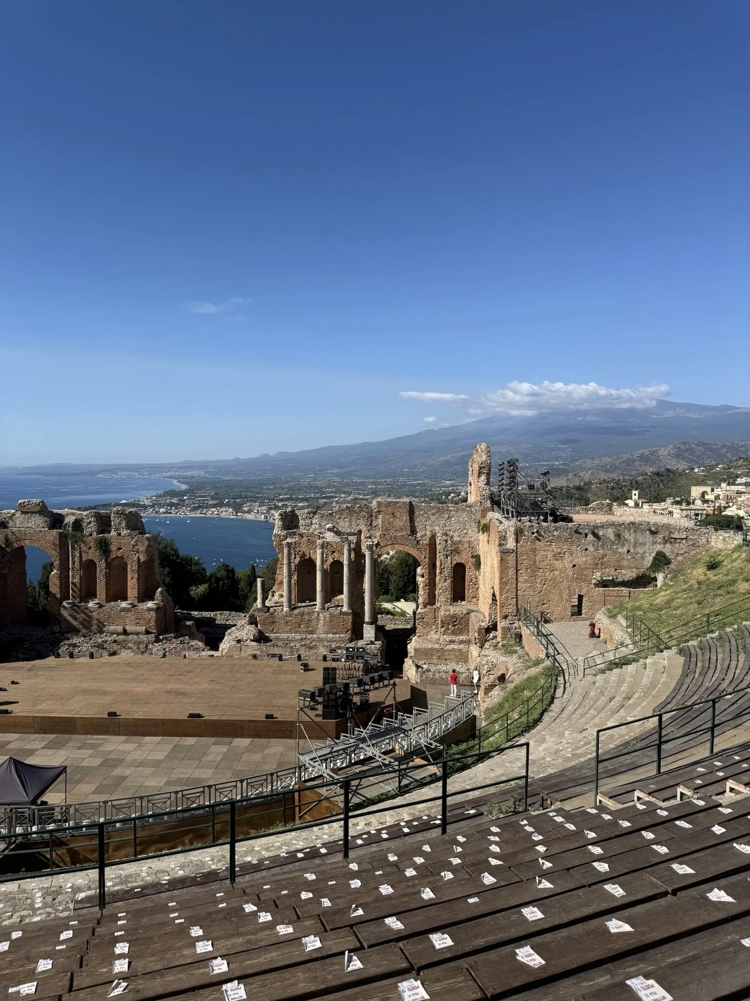 Ancient Greek theater ruins overlooking Taormina's coastline and Mount Etna in Sicily, Italy