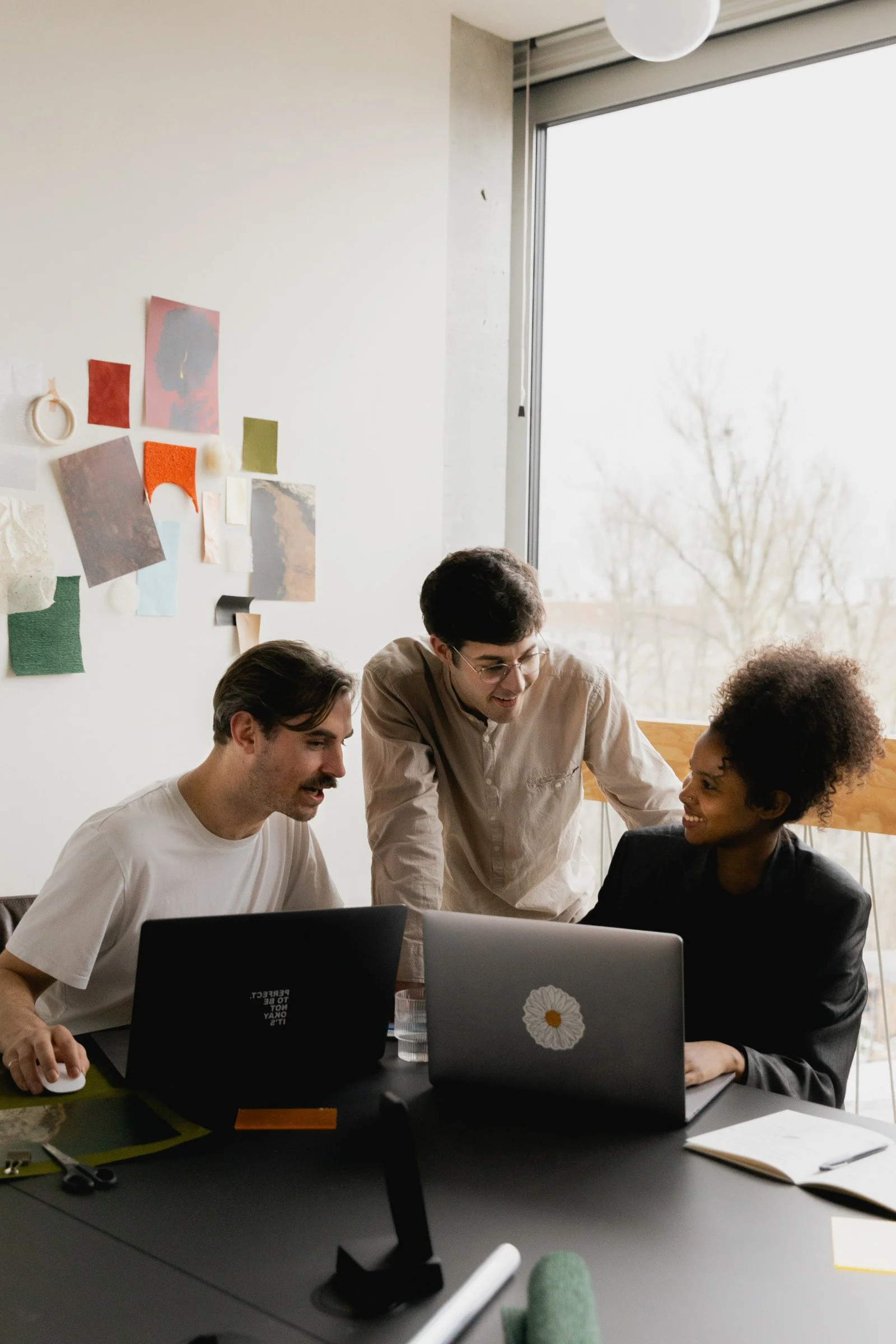 three employees collaborate in a modern office setting