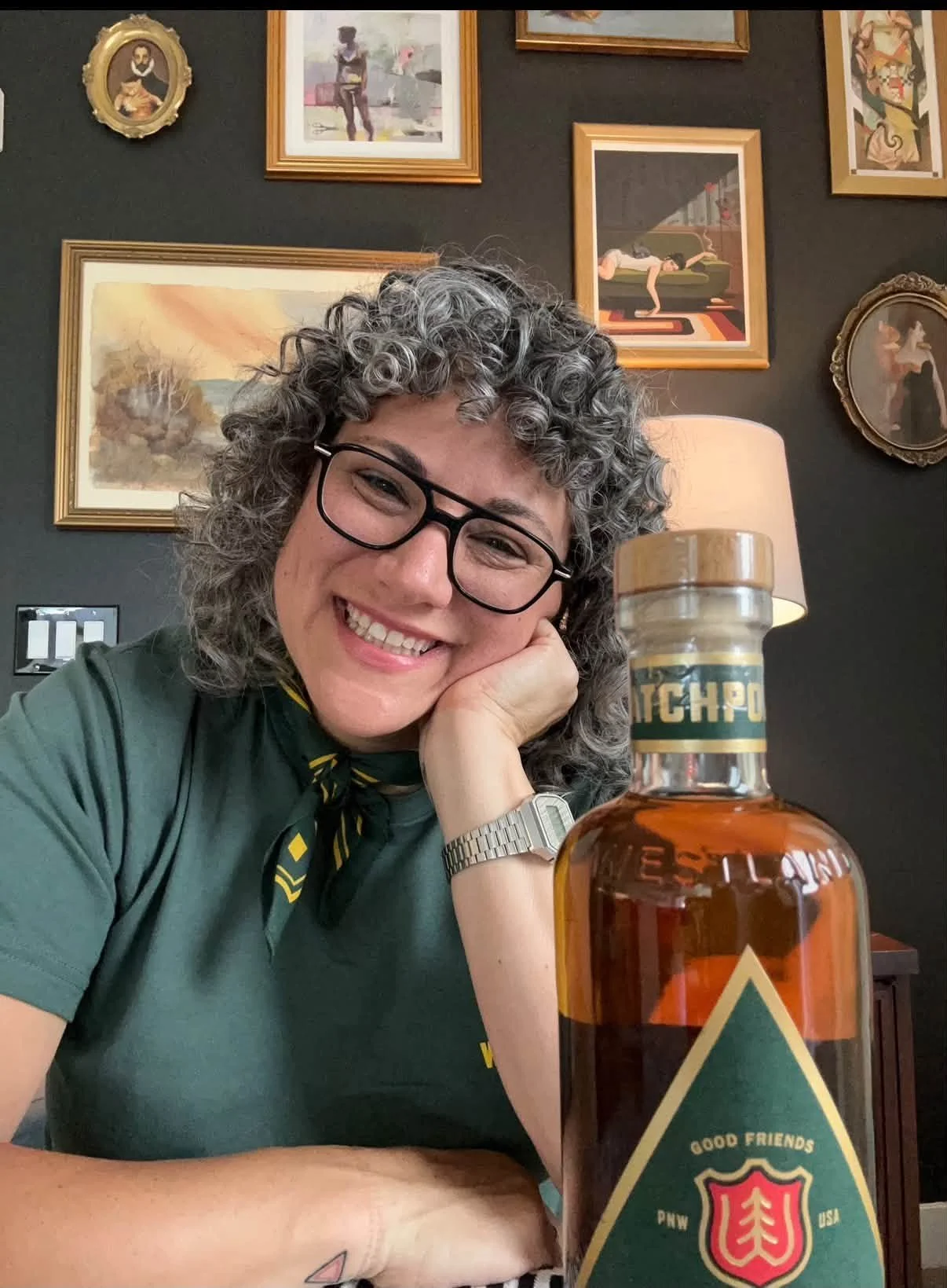 Lana Lauriano smiling beside a Westland whiskey bottle.