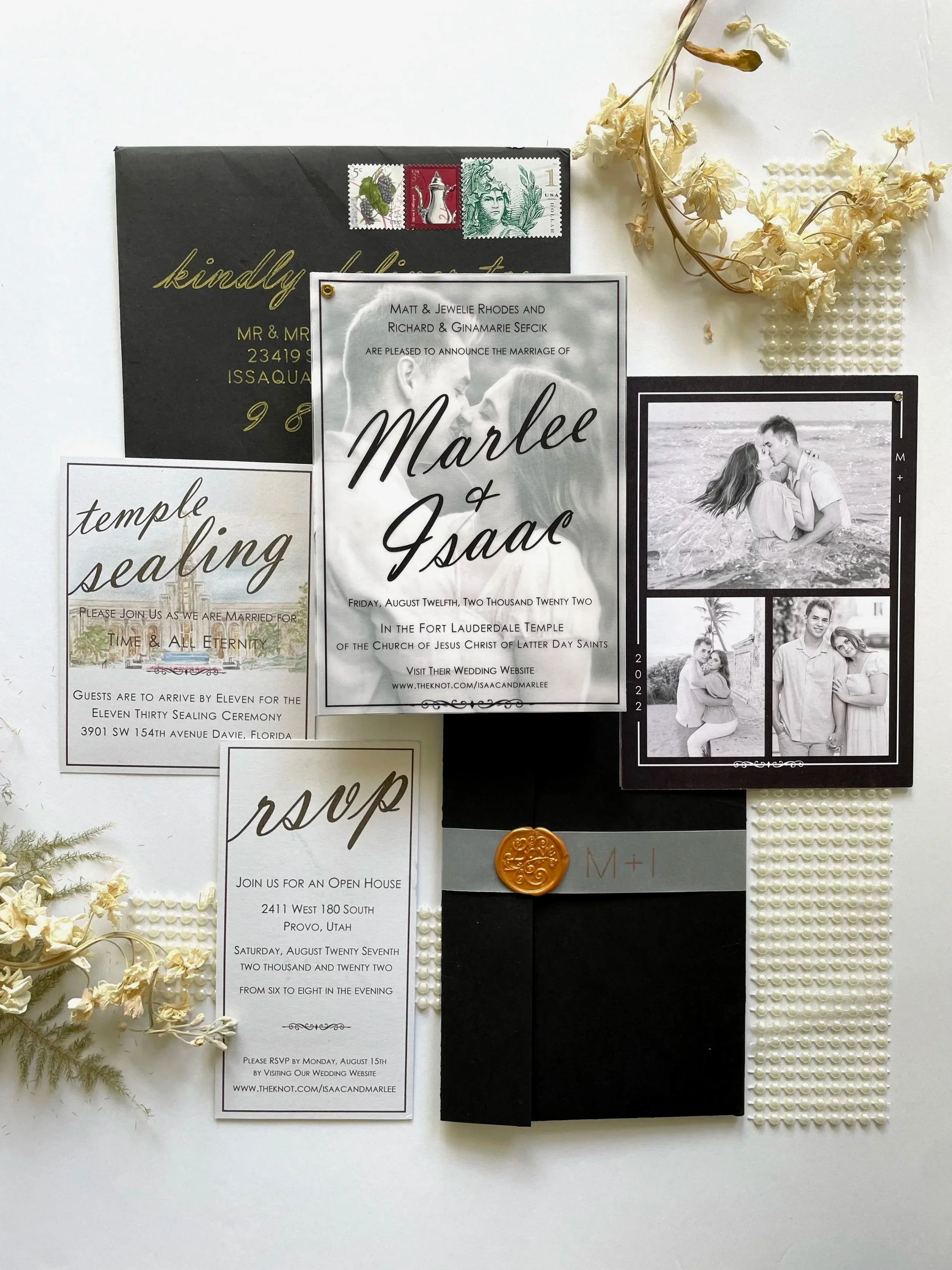 Wedding stationery photo collage invitation with vellum overlay, detail card with custom venue watercolor, rsvp card, gold wax seal, black sleeve, vellum belly band, vintage postage stamps, engagement photos, pearls, and black-and-gold envelop.