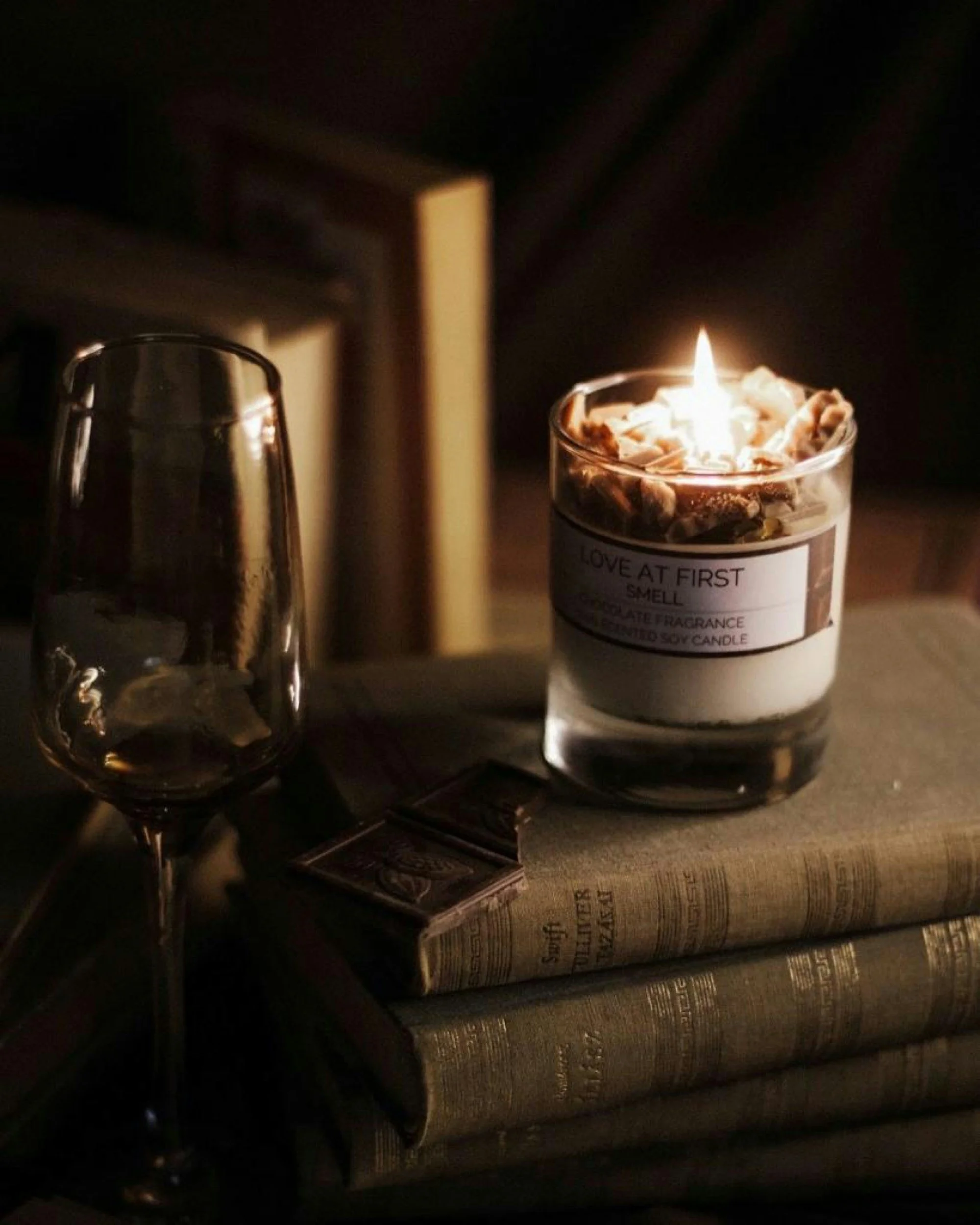 A cozy still life of books, a teacup, and flowers on a wooden table