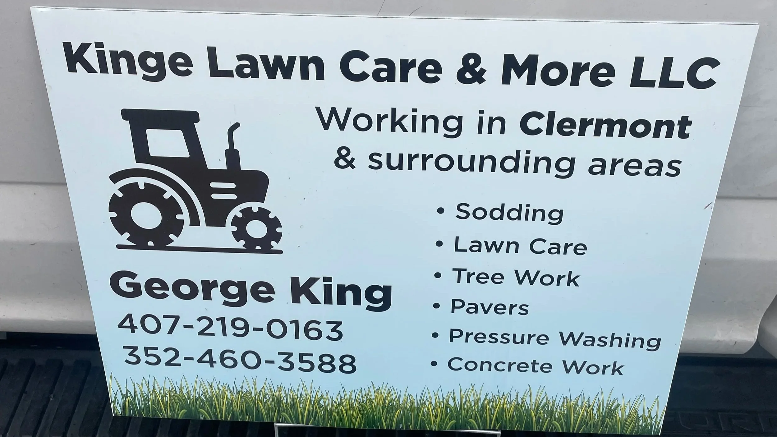 Sign for Kinge Lawn Care & More LLC in Clermont, offering sodding, lawn care, tree work, pavers, pressure washing, and concrete work.