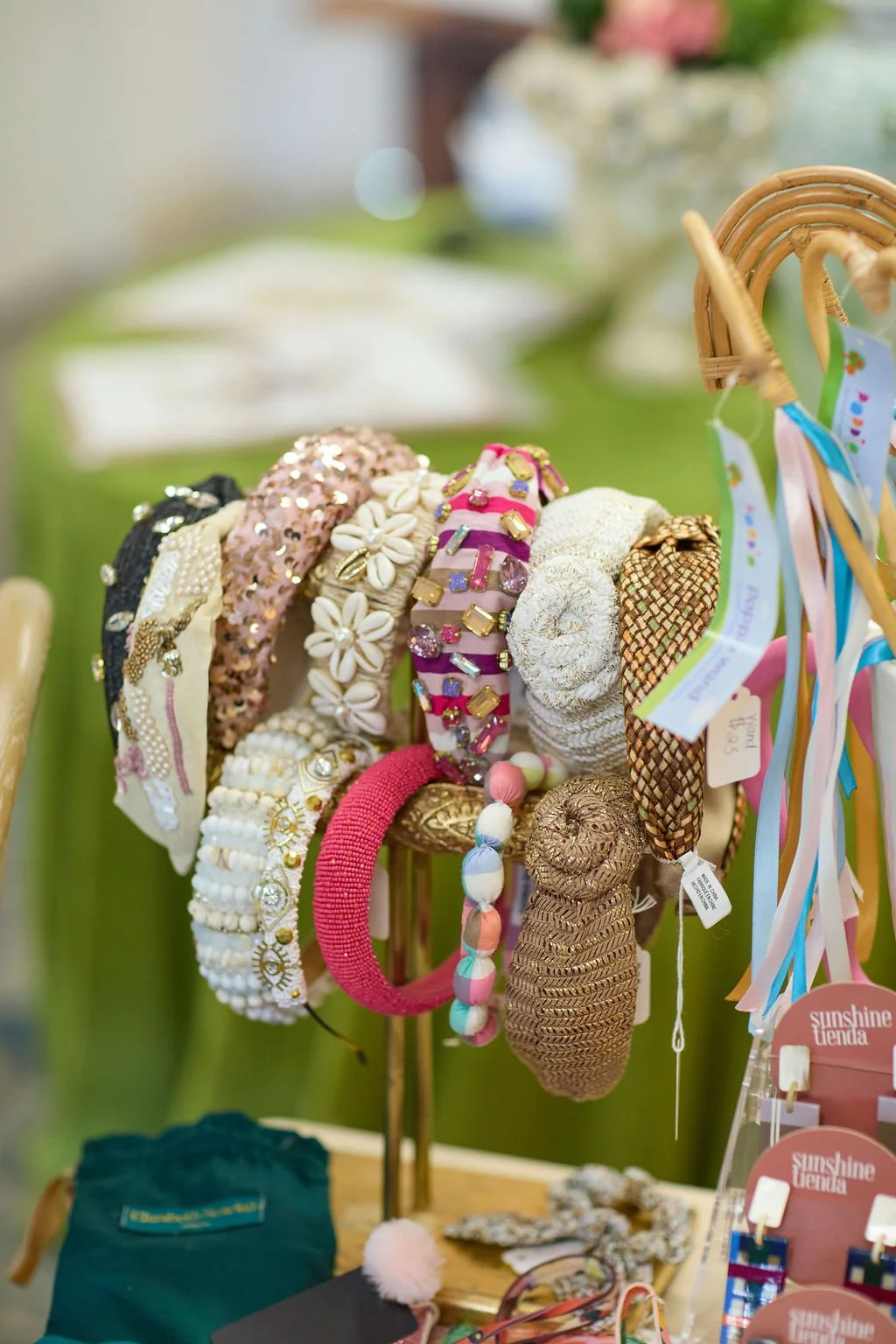 Colorful handmade headbands and hair accessories displayed on a boutique rack