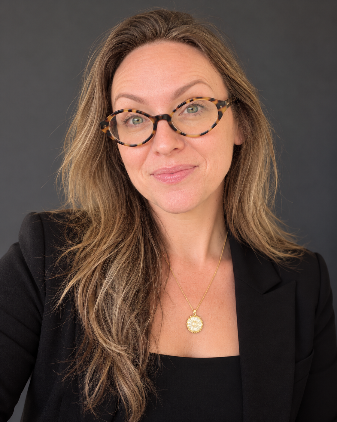 Attorney Leah E. Gillespie in a black blazer and tortoiseshell glasses.