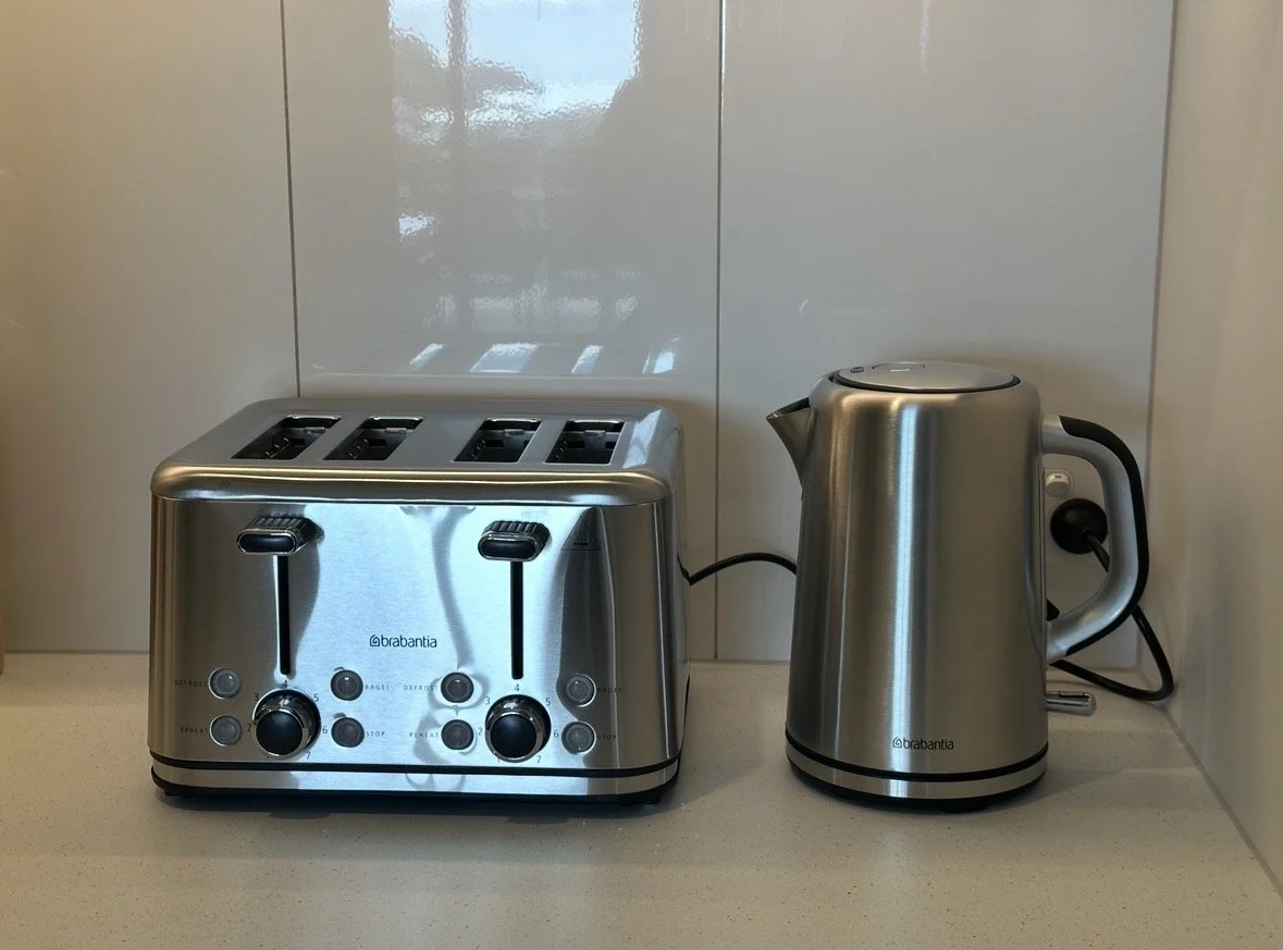 Brabantia stainless steel four-slot toaster and electric kettle on a kitchen countertop