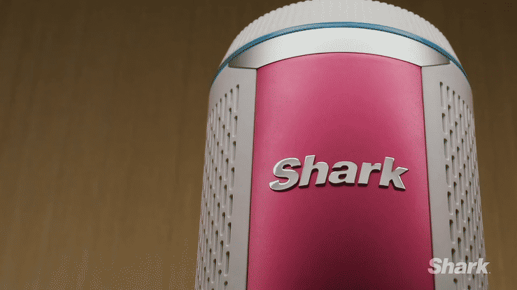 Close-up of a pink and white Shark vacuum cleaner with the Shark logo