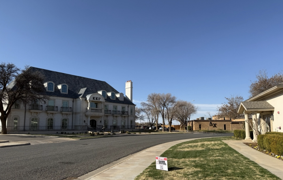 Sorority and fraternity houses under a blue sky