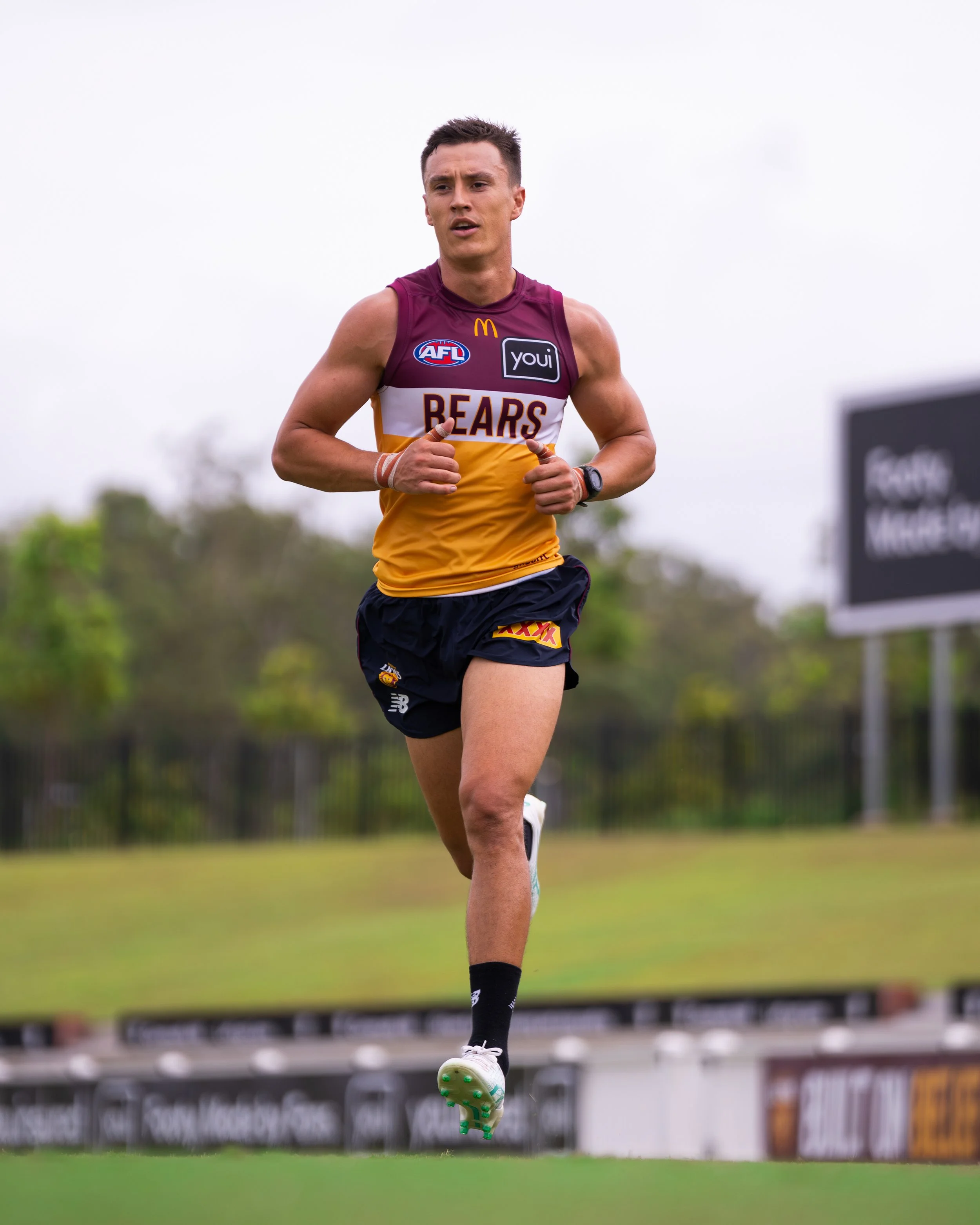 Australian rules football player in a Brisbane Bears uniform running on a grassy field