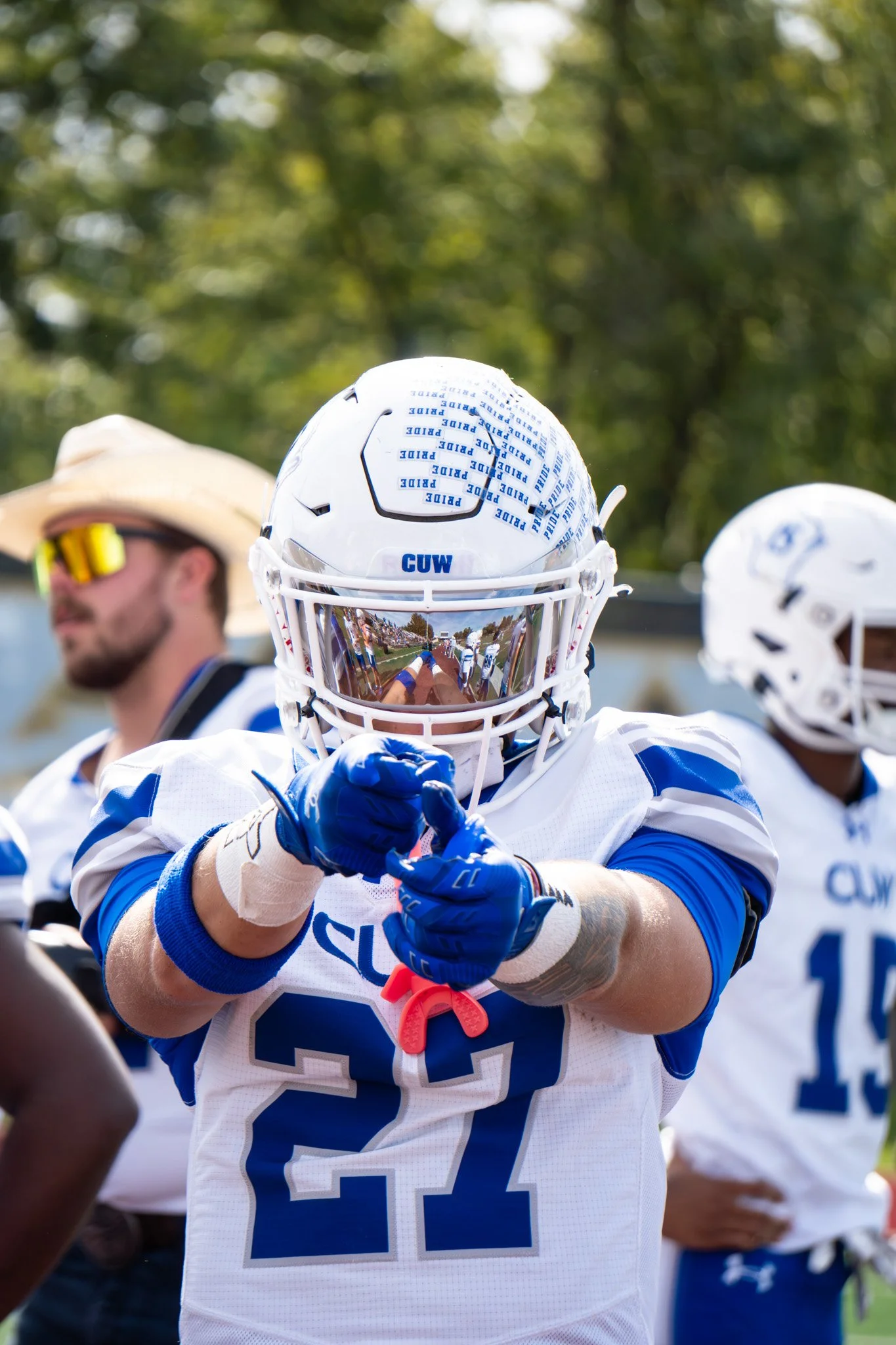 George Washington University lacrosse player in white and blue uniform with a reflective helmet visor and number 24 jersey