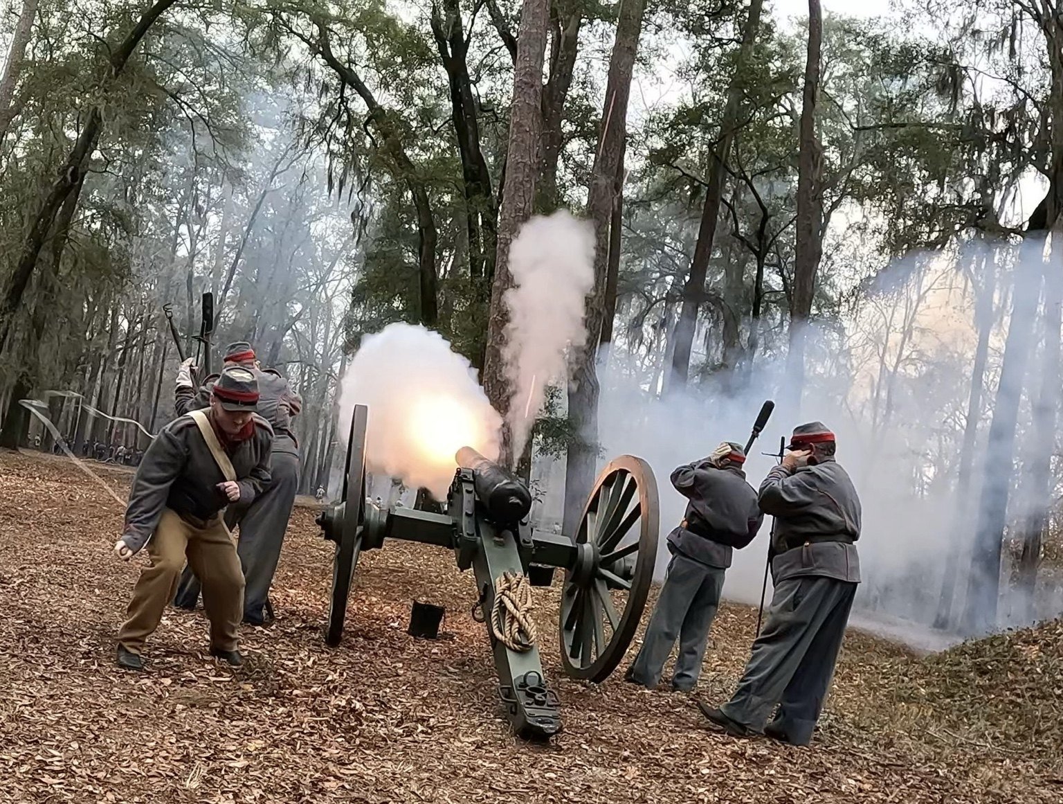 Modern Waccamaw Light Artillery crew firing a cannon in woodland