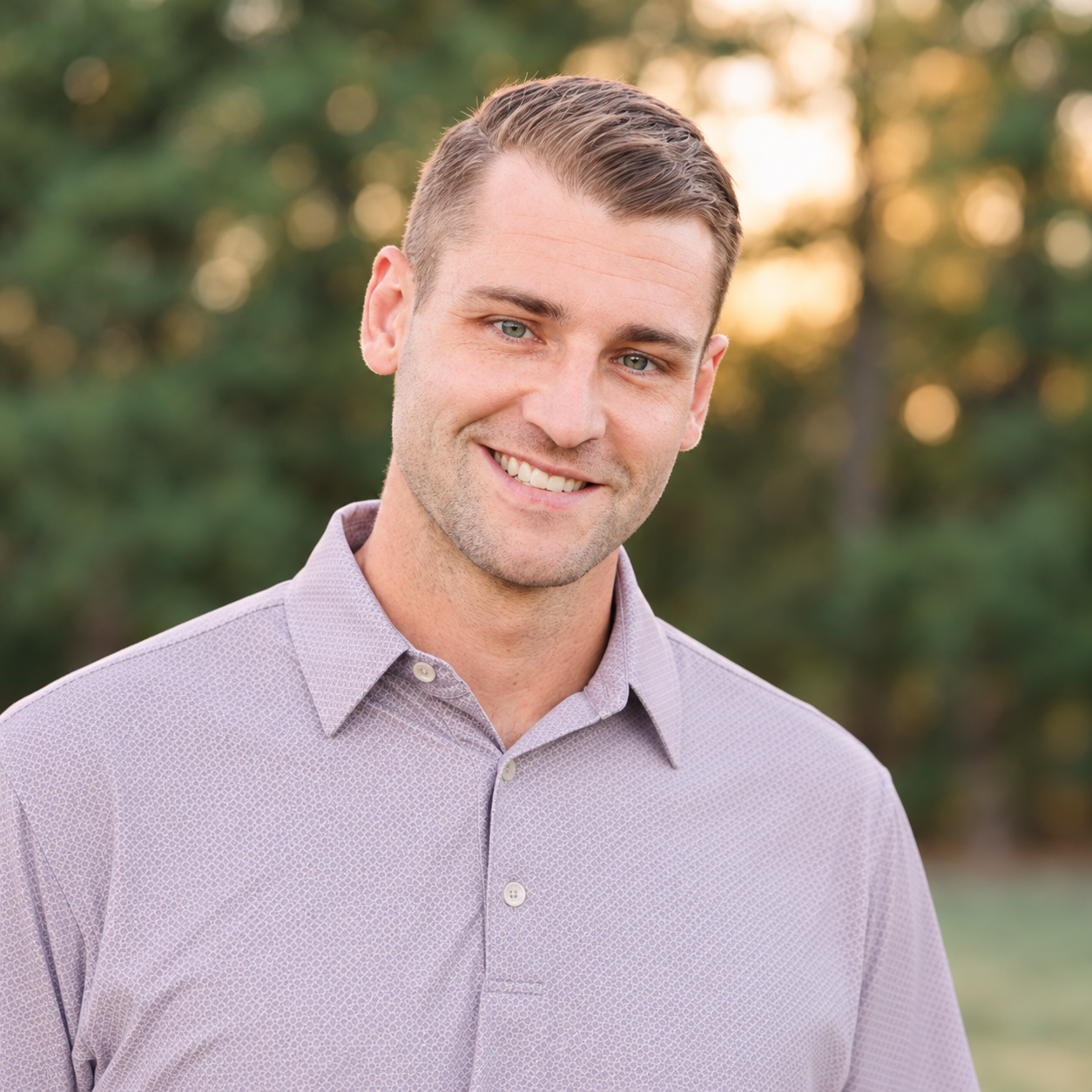 Kyle Ham, P.E in a lavender patterned button-down shirt outdoors at sunset