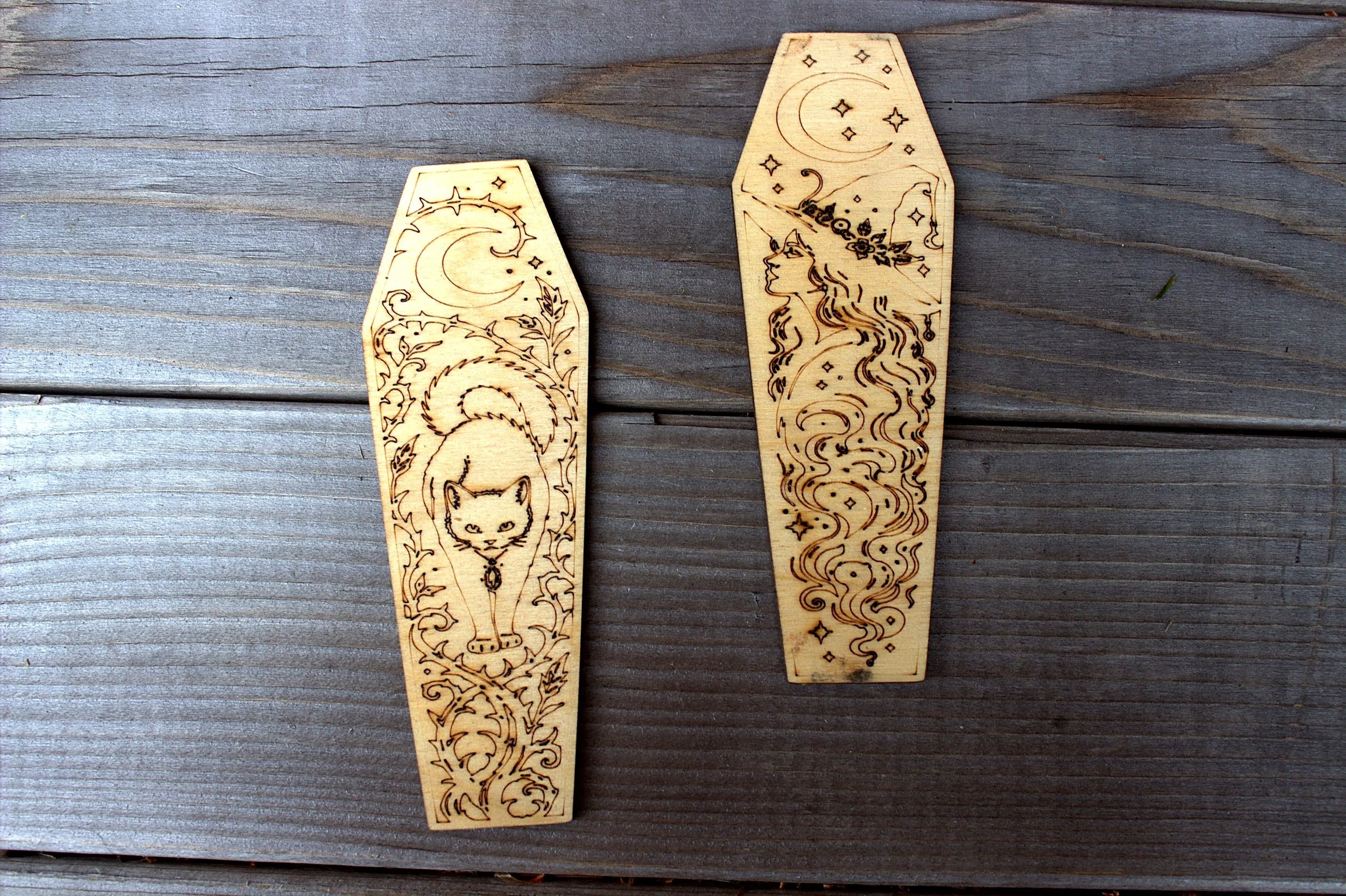 Laser-engraved coffin-shaped bookmarks — cat and celestial designs