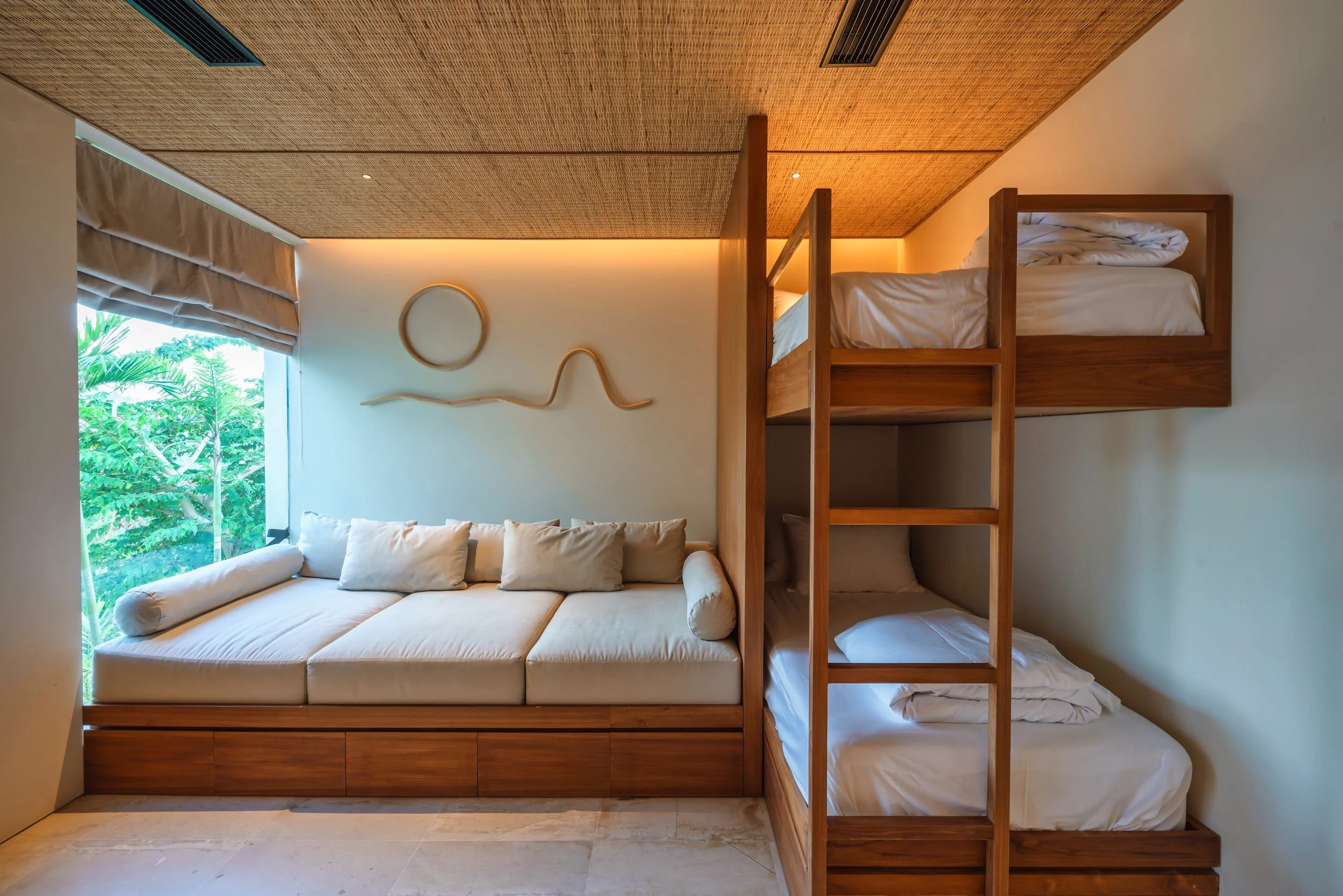 Bunk room at Villa Kai Lani with two king single bunk beds and a cushioned daybed